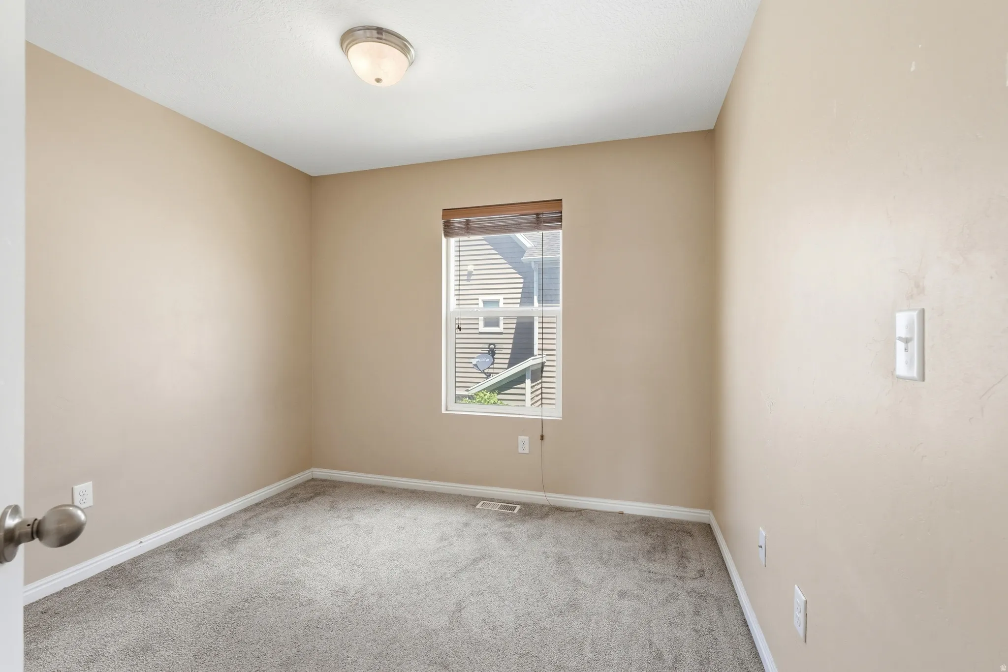 Bedroom featuring neutral paint, gray carpeting, a flush mount ceiling light, and white trim