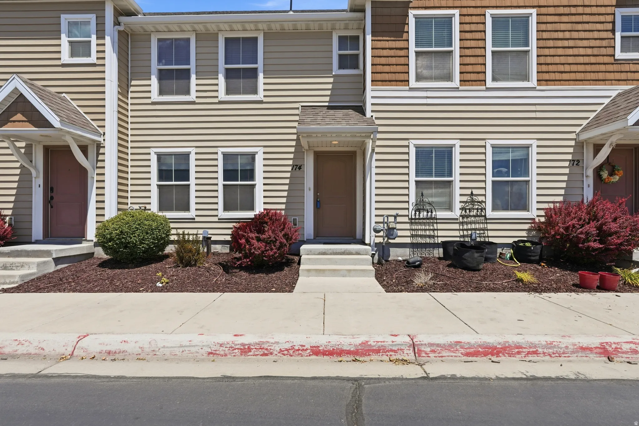 Townhome exterior featuring horizontal siding and shake siding accents