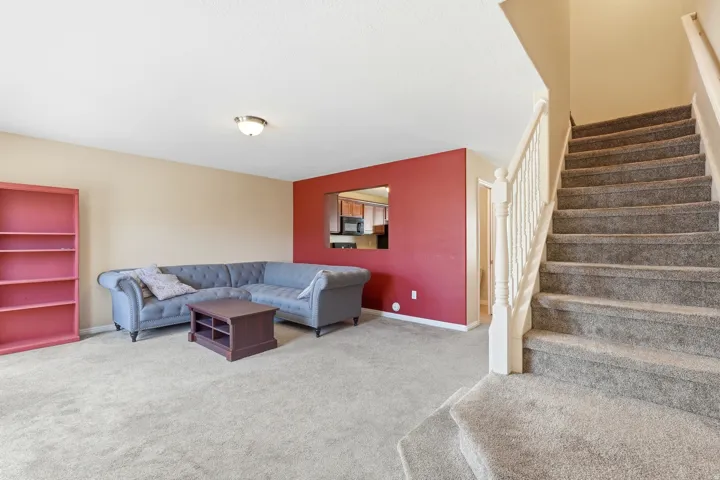 Carpeted staircase with white balusters