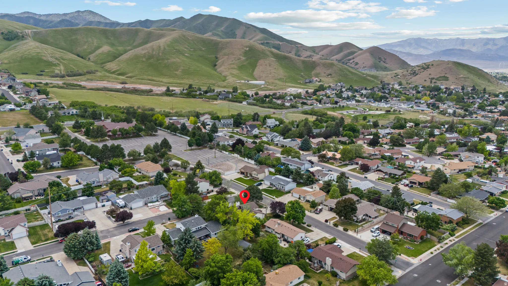 Residential community featuring mature trees and mountain backdrops