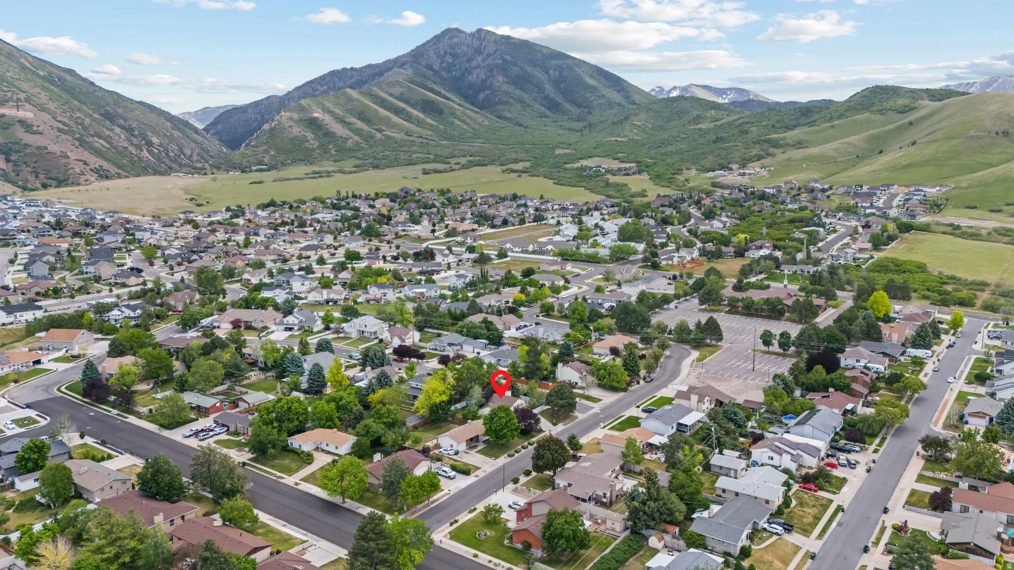Residential community nestled against a prominent mountain backdrop