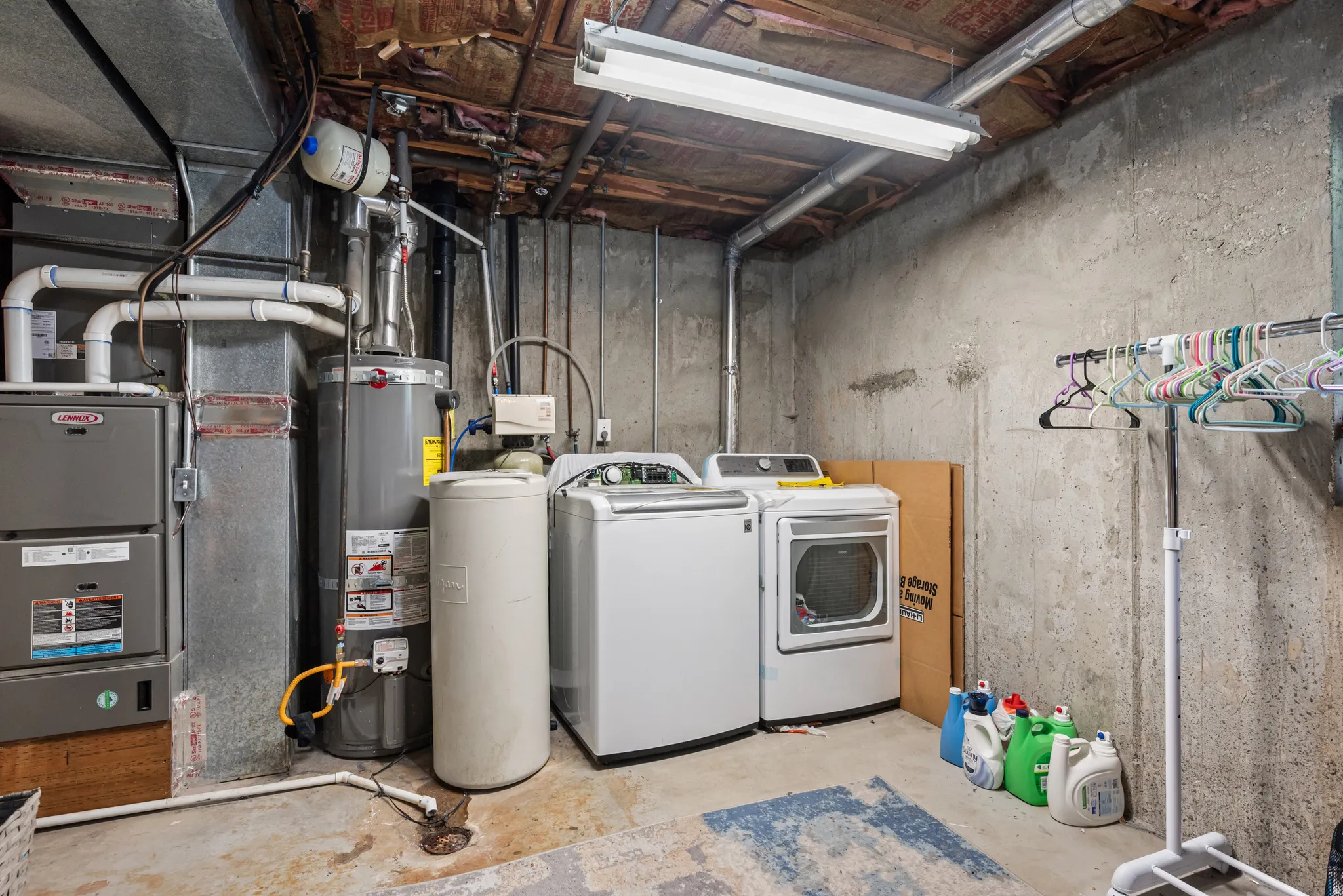 Laundry area featuring a side-by-side washer and dryer, water heater, and furnace