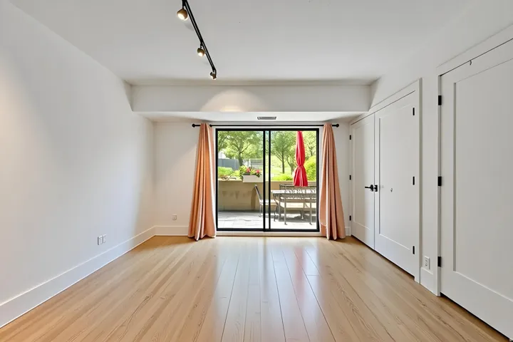 Interior space featuring hardwood flooring and white walls
