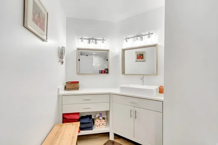 Modern vanity with a rectangular vessel sink, quartz countertop, and integrated storage
