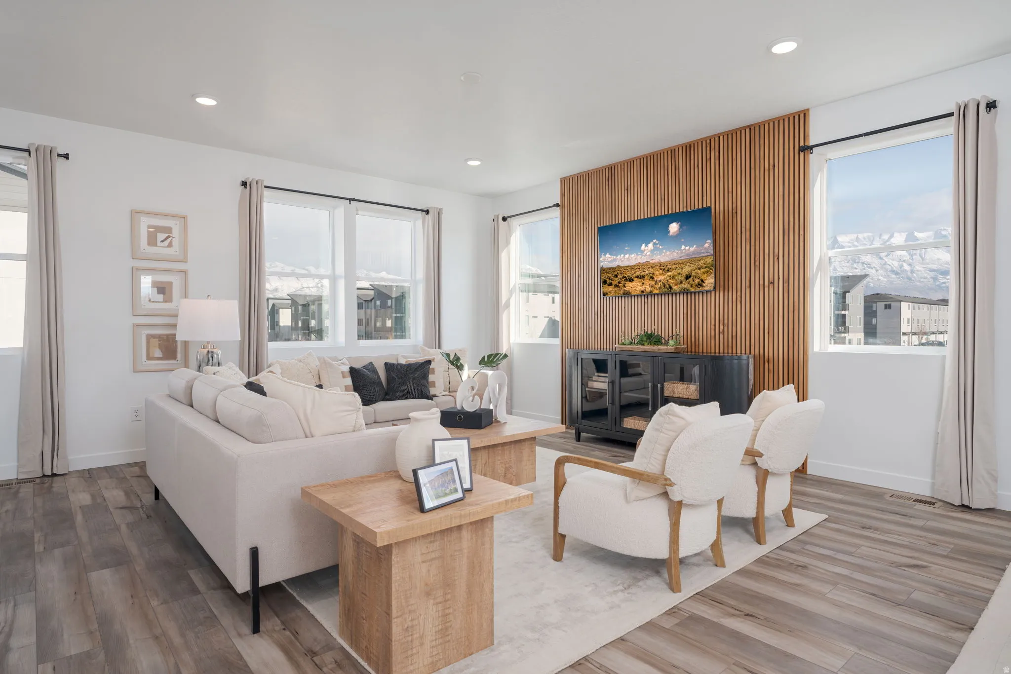 Living area featuring wood-finish flooring, recessed lighting, and expansive windows