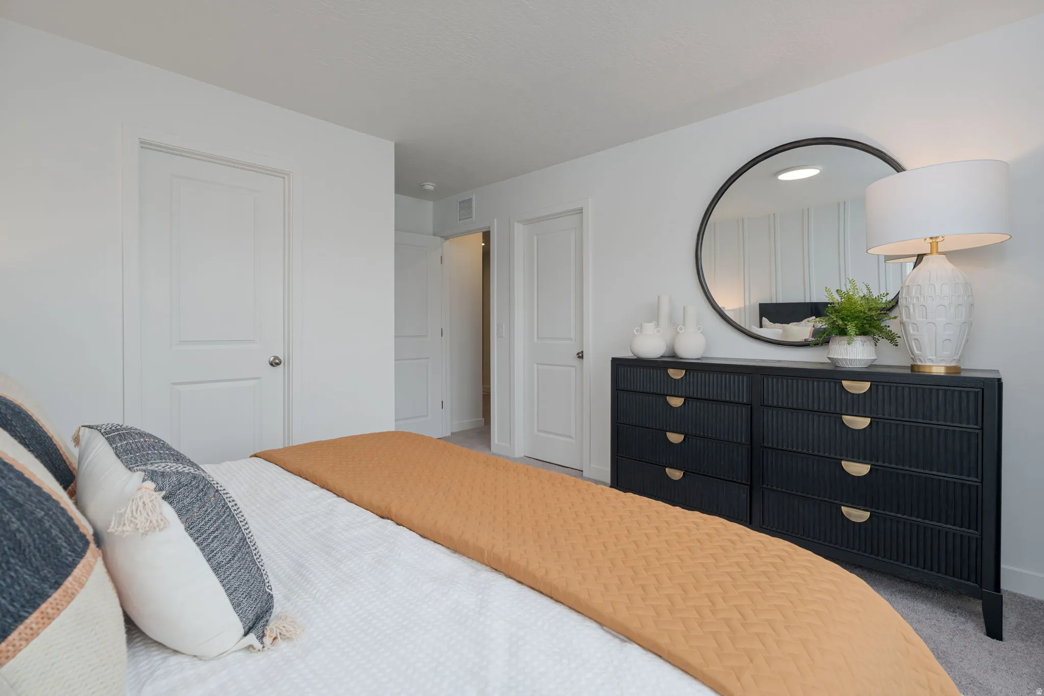 Carpeted bedroom with white walls and a white textured ceiling