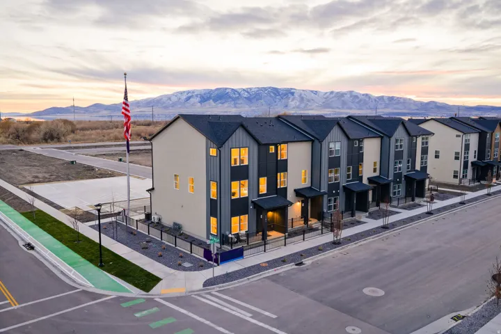 Contemporary townhomes featuring multi-toned siding and dark-pitched roofs