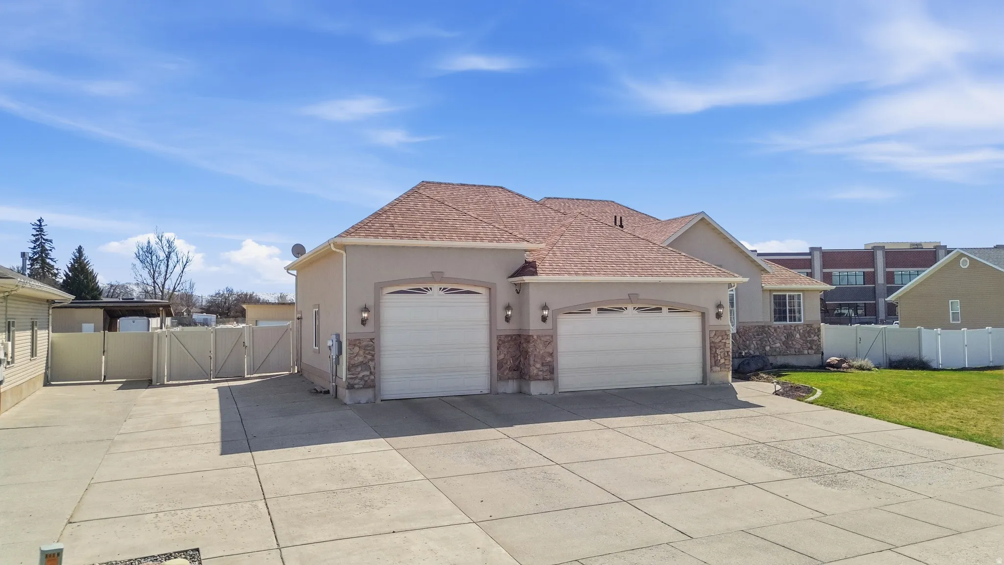 Two-car garage with arched entryways and decorative sconces