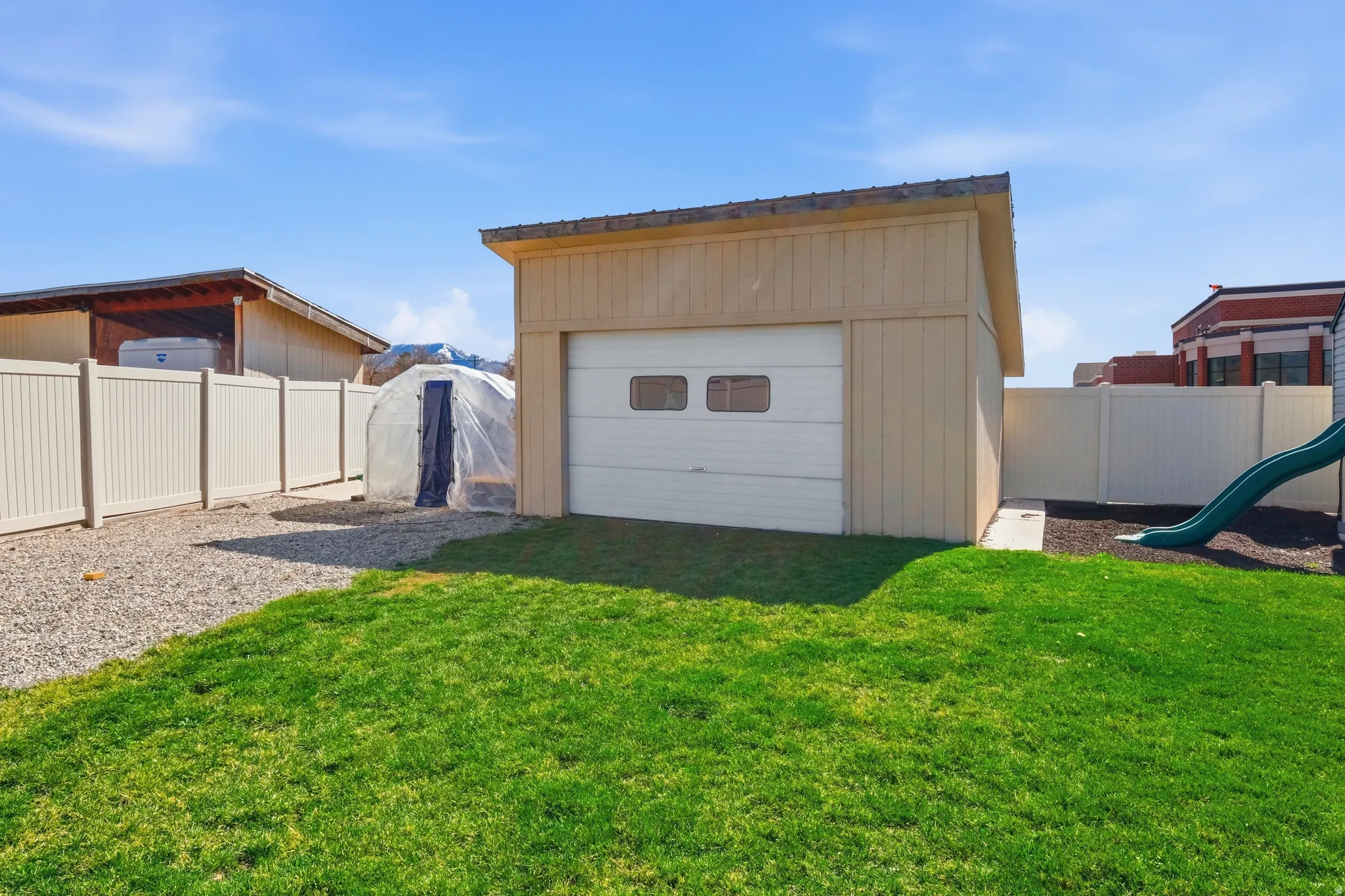 Detached garage with a roll-up door and two windows