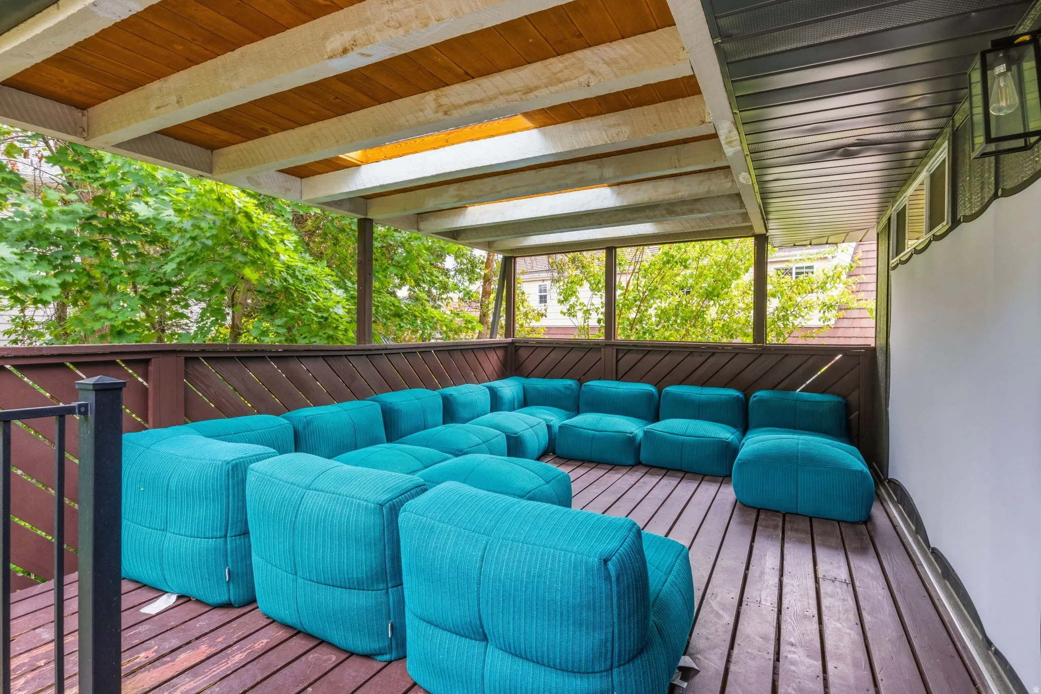 Covered outdoor deck featuring wood-finish flooring