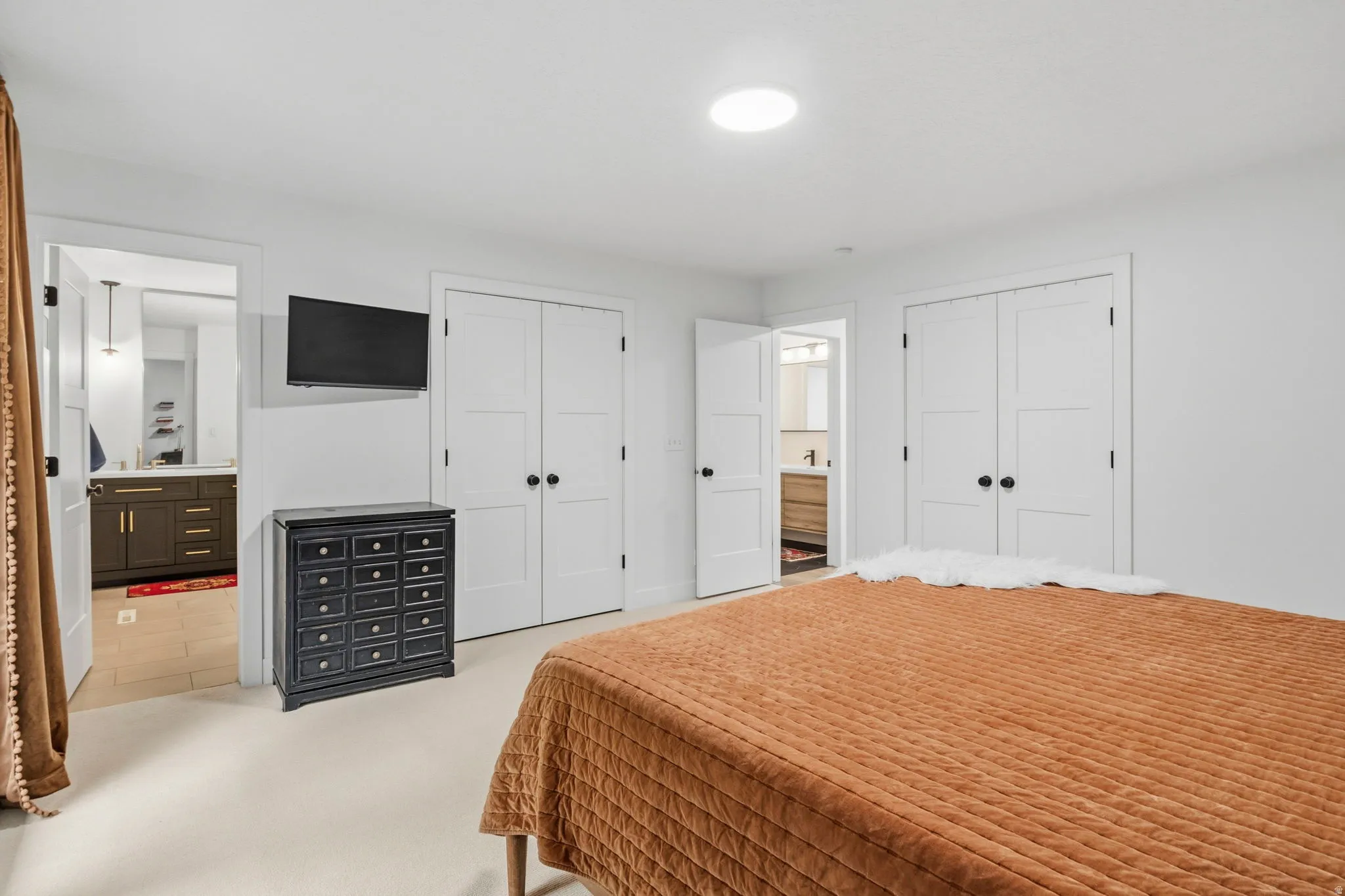 White wall finishes throughout, complemented by white interior doors featuring matte black hardware