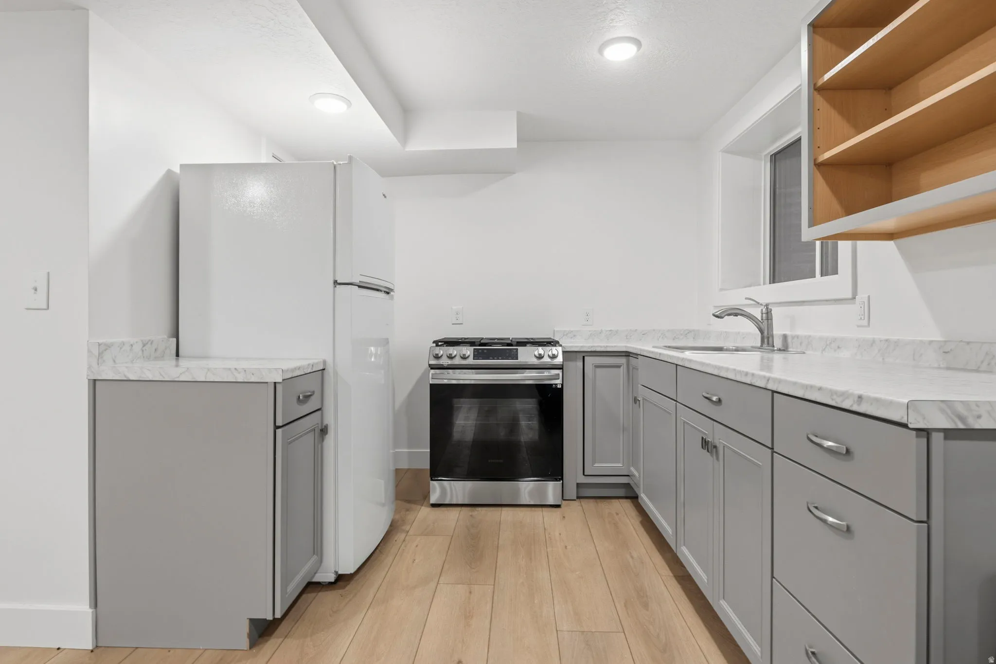 Kitchen featuring light wood-finish flooring and recessed lighting