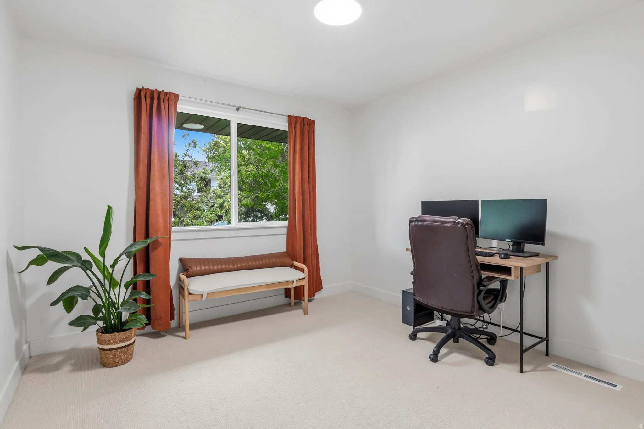 Bright room featuring a large window, plush carpeting, and recessed ceiling lighting