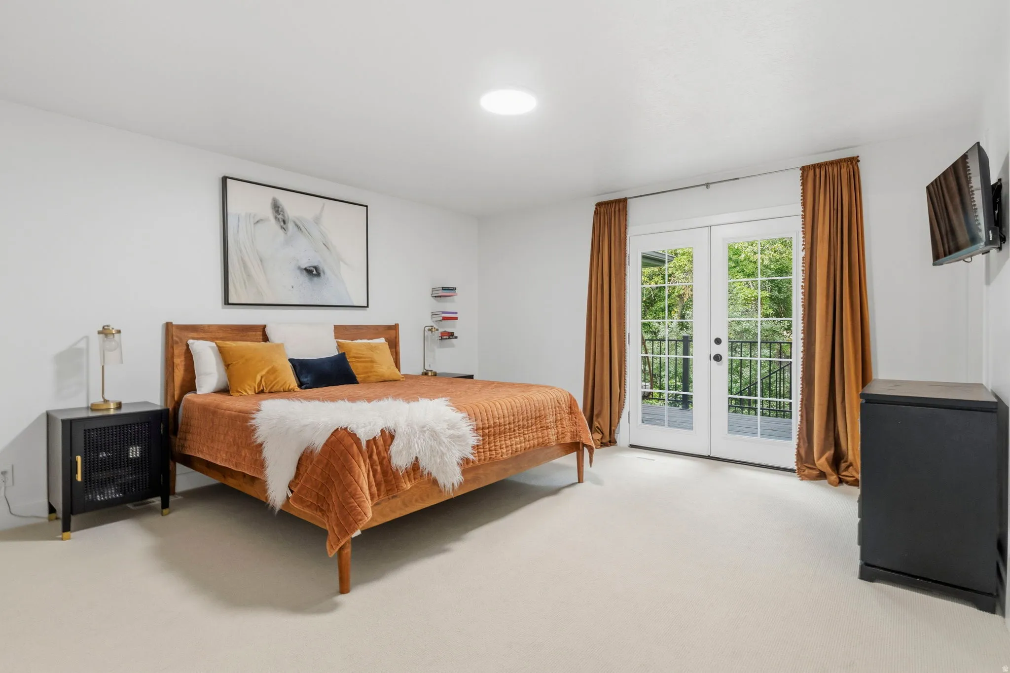 White double French doors with transom windows open to an exterior balcony