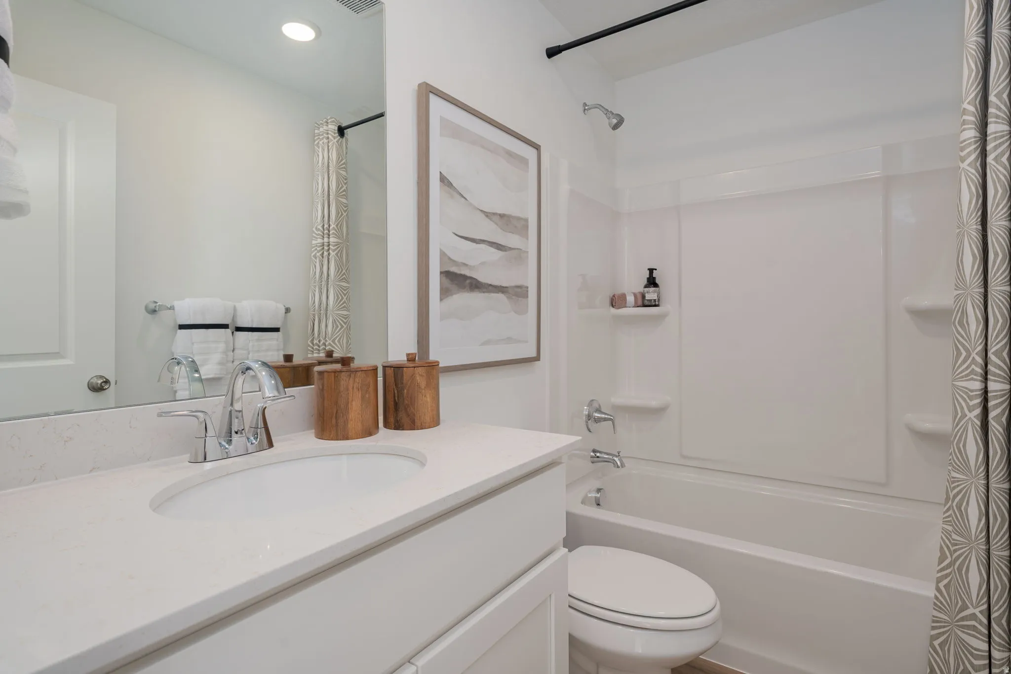 White vanity with an integrated oval sink and chrome faucet