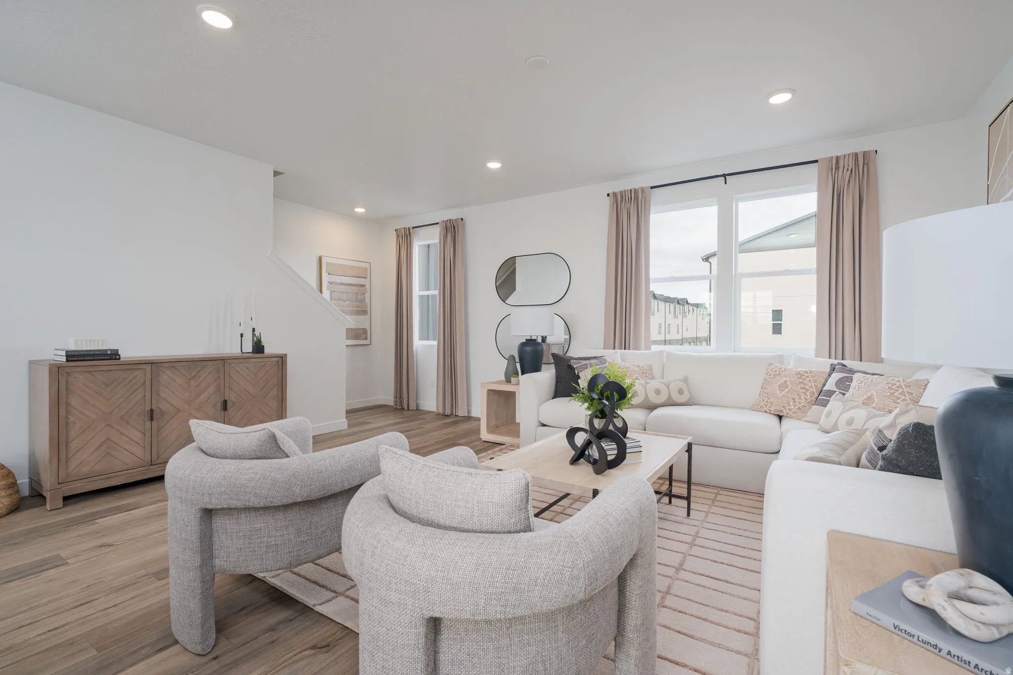 Bright living area featuring recessed lighting and wood-finish flooring