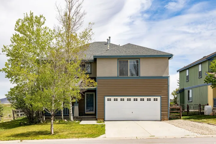 Two-story residence featuring a shingled roof, stucco, and horizontal siding