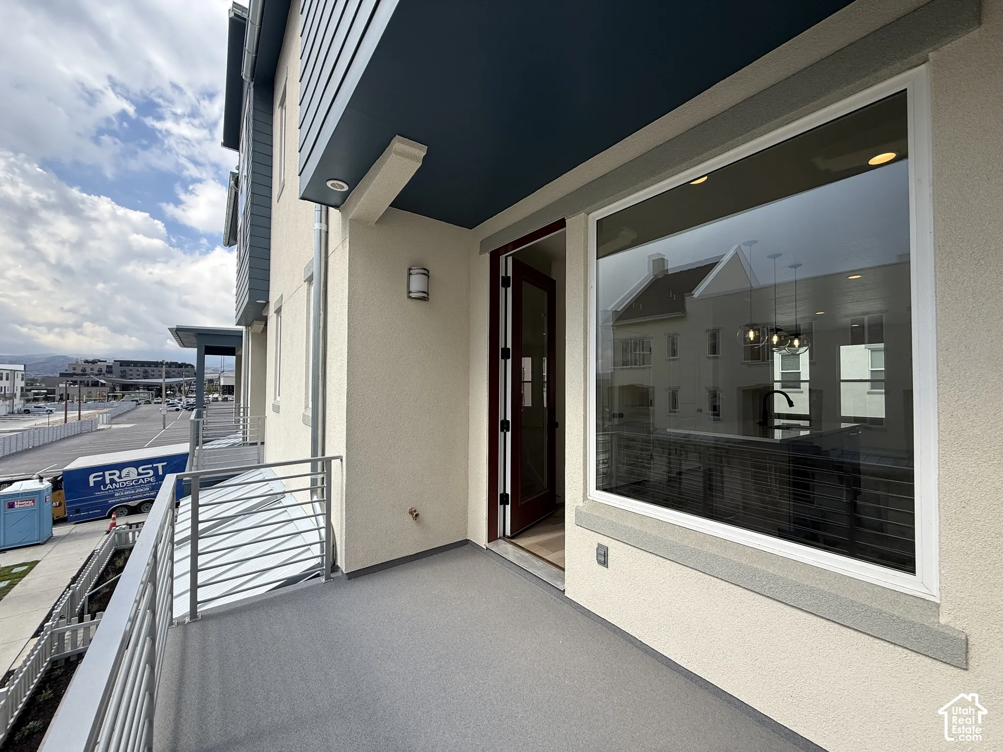 Private balcony featuring textured flooring and a horizontal bar railing