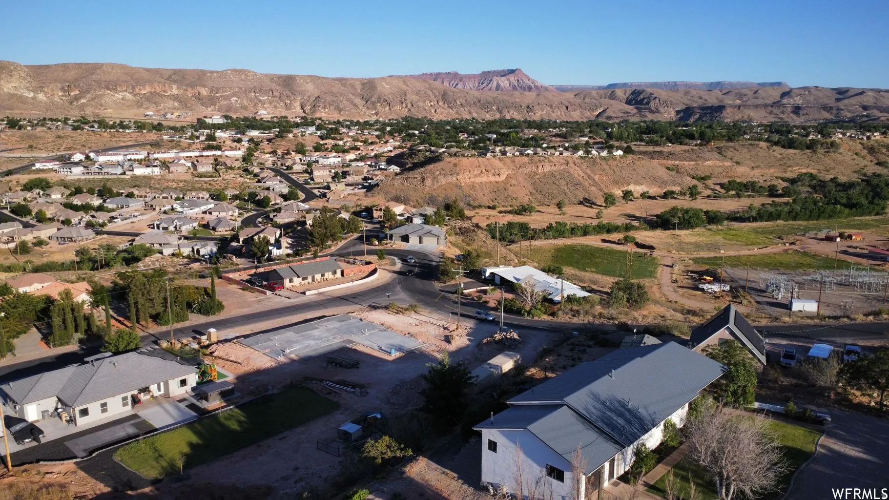 Residential community with varied rooflines and a mix of paved and unpaved roads
