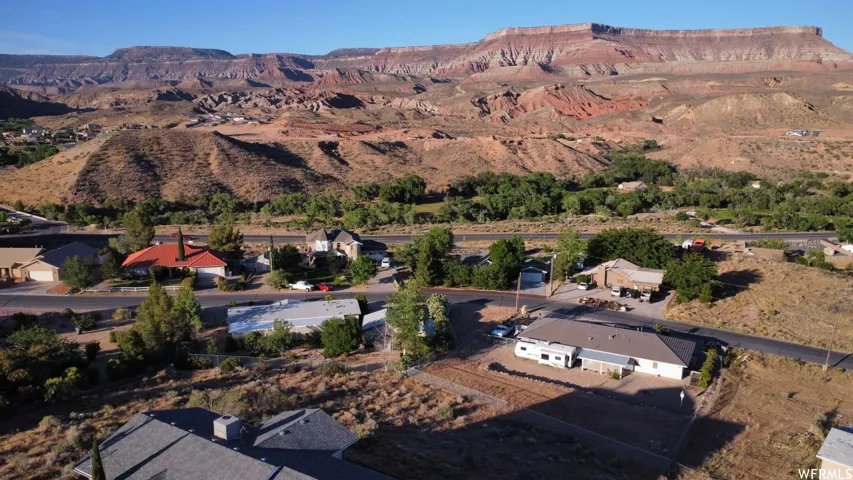 Expansive desert landscape featuring distant mountains and a winding road