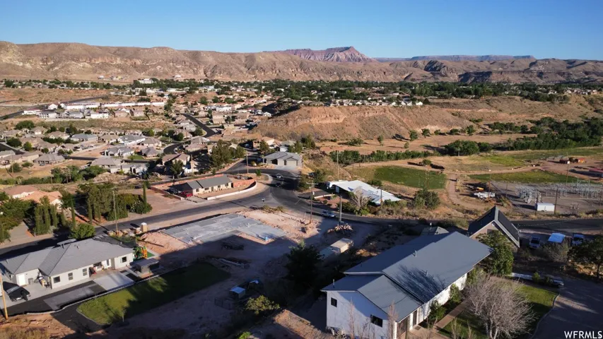 Residential community with varied rooflines and a mix of paved and unpaved roads