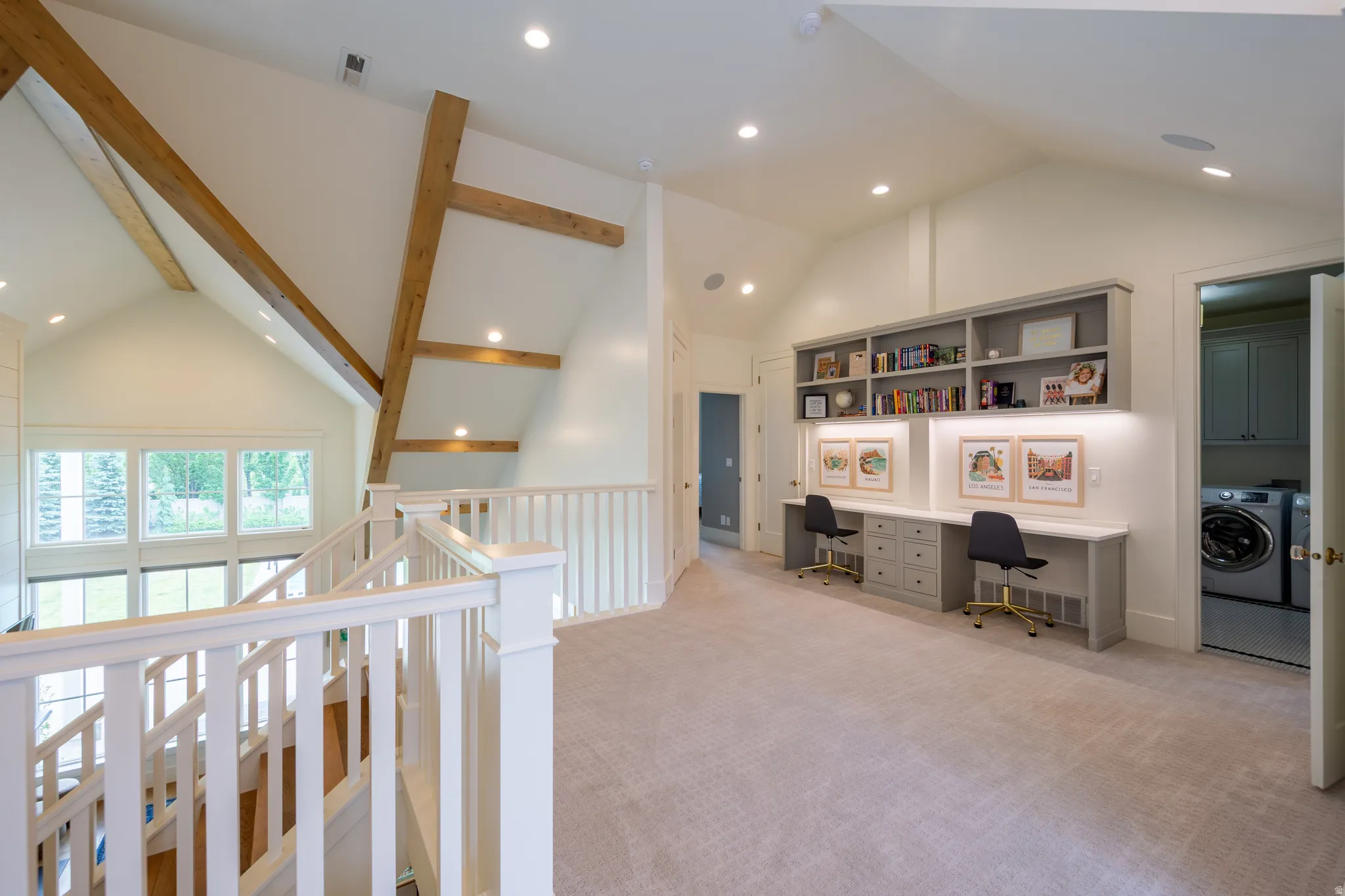 Loft area featuring vaulted ceilings with exposed wood beams, a built-in double desk with shelving and task lighting, recessed lighting, and carpeted flooring
