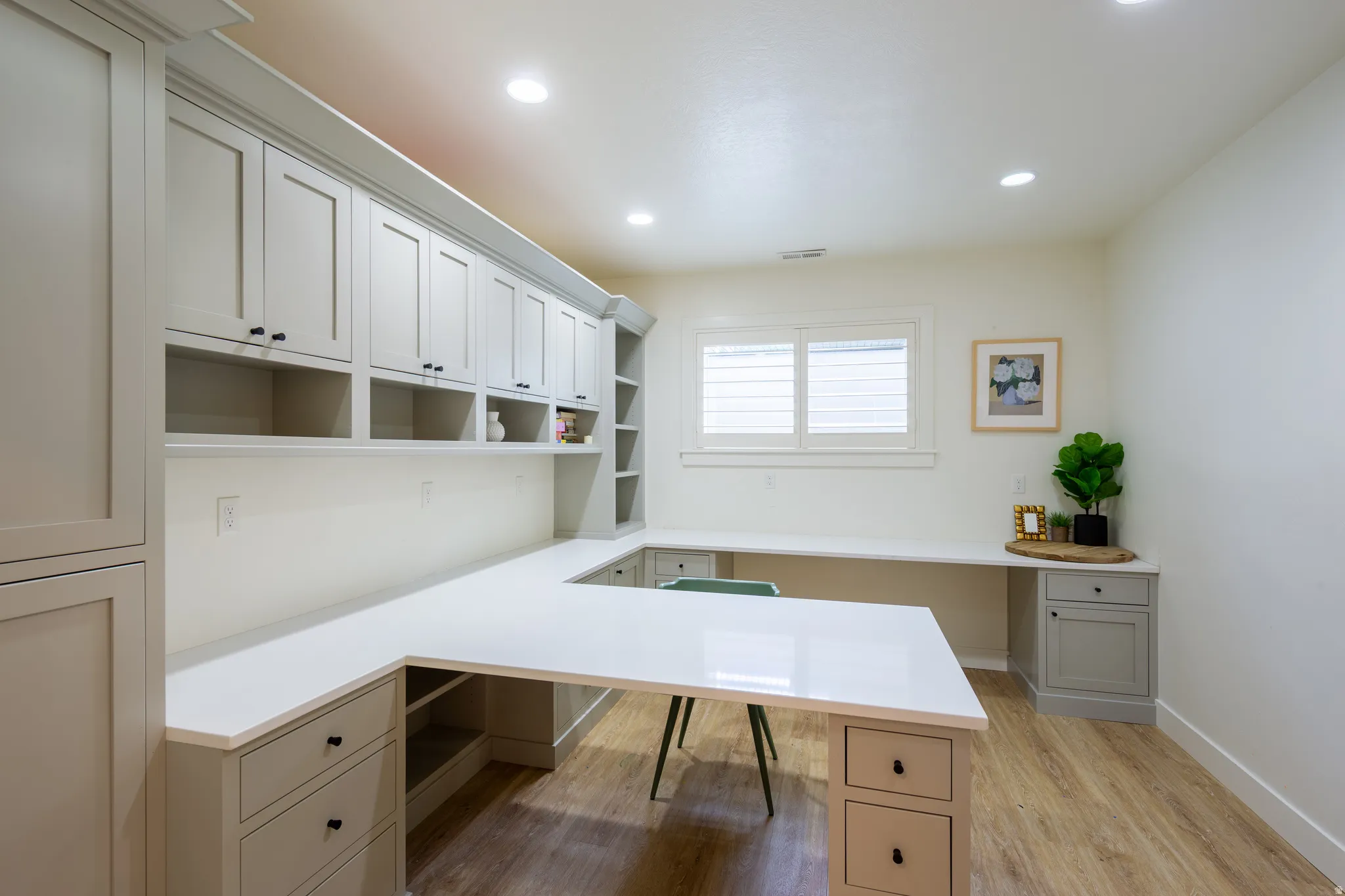 Expansive built-in desk with a U-shaped configuration and light-toned countertops