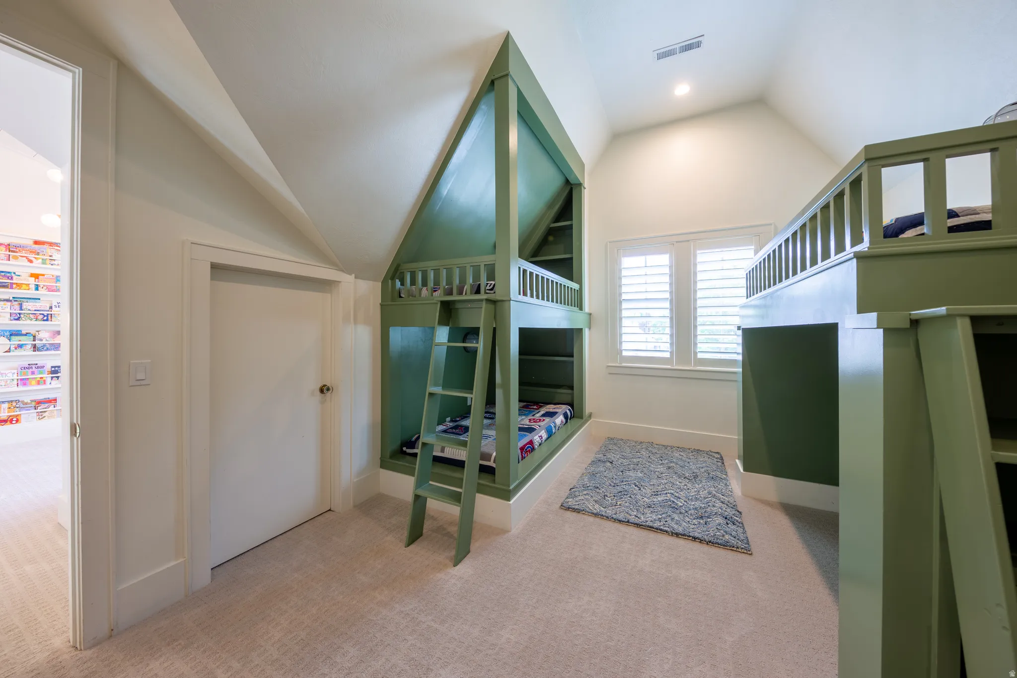 Built-in bunk beds with integrated ladders and shelving