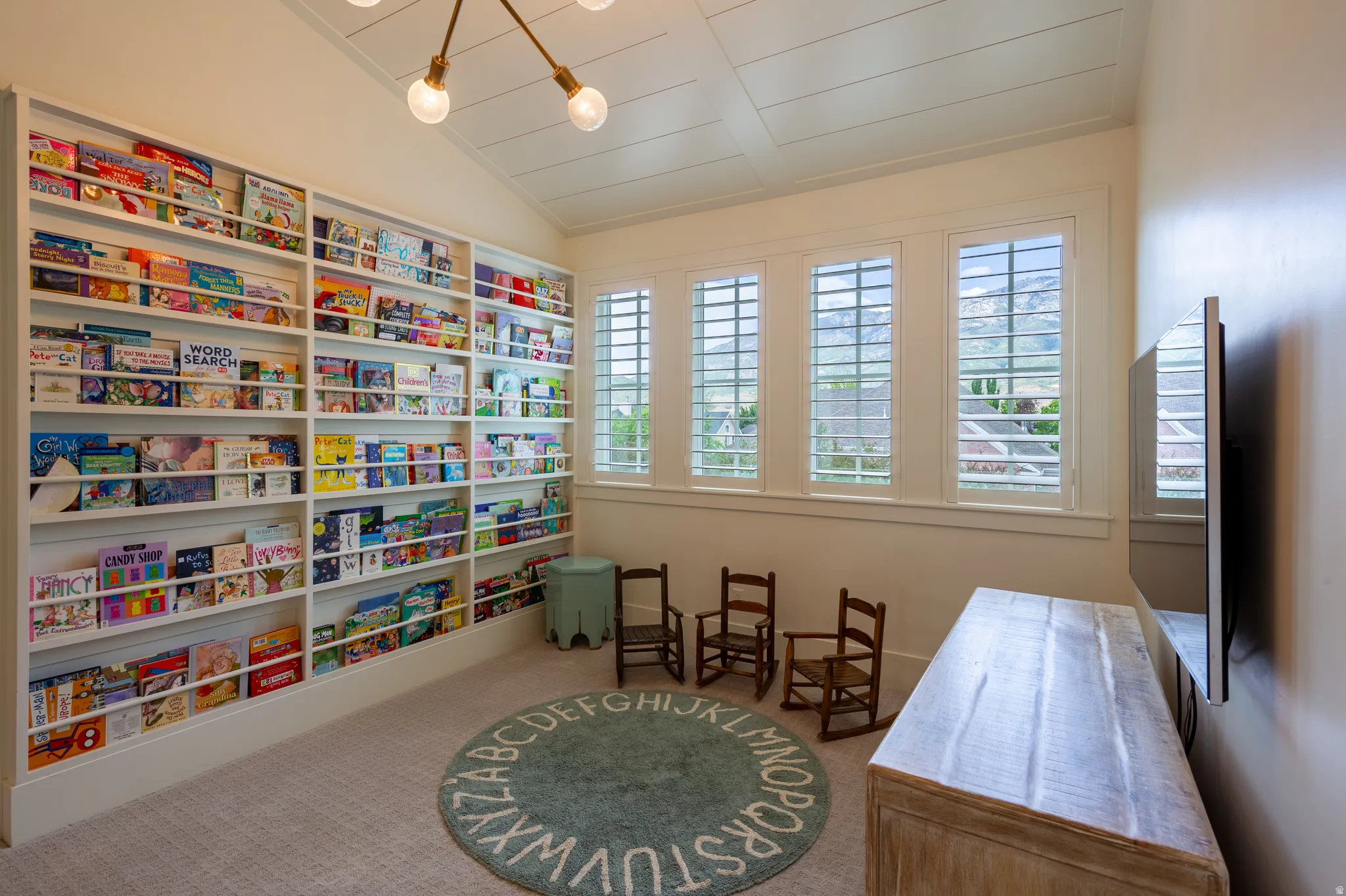 Custom built-in shelving extends across a full wall in this room, providing extensive storage