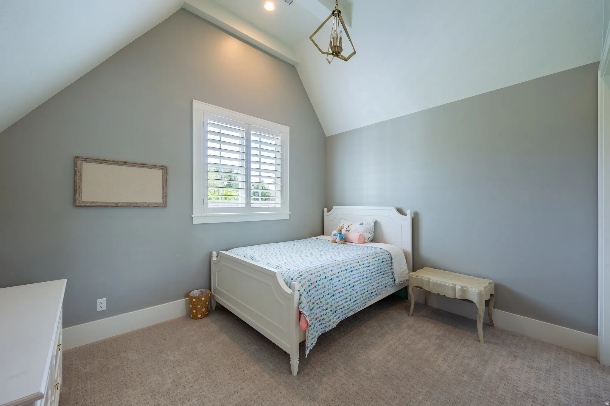 Spacious room featuring vaulted ceilings, light gray walls, a window with plantation shutters, and recessed lighting