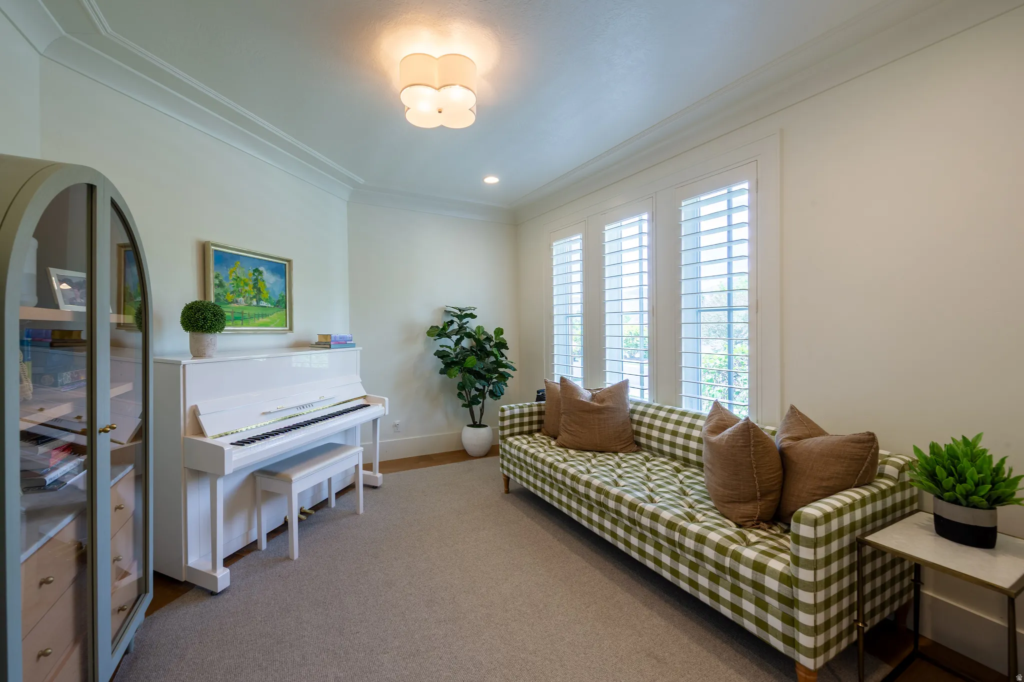 Interior space featuring crown molding, recessed lighting, and a decorative ceiling fixture