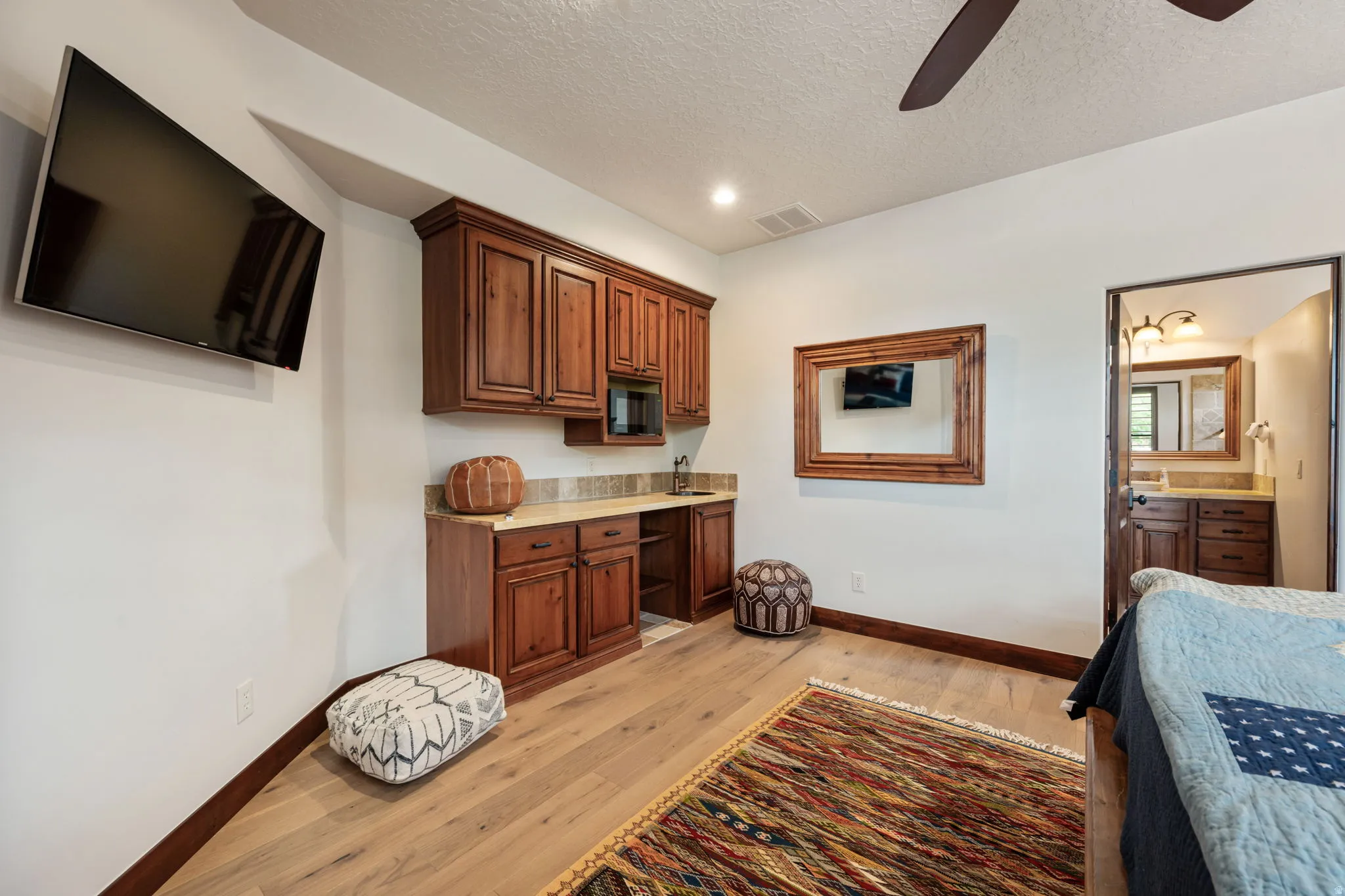 Warm wood-finish flooring complements the built-in cabinetry and stone-look countertop