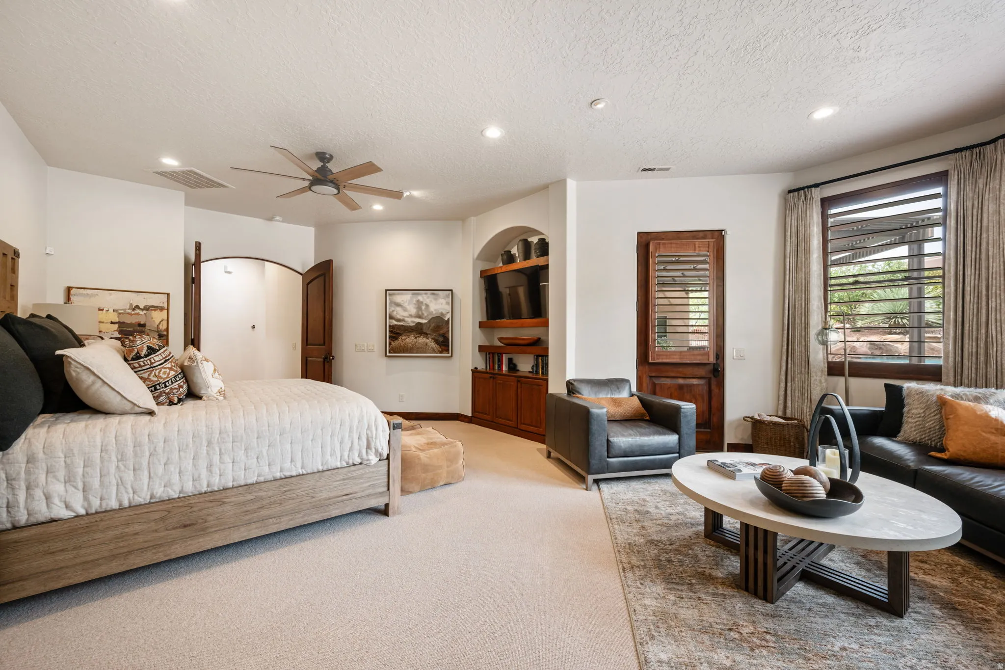 Spacious room featuring neutral carpeting, a ceiling fan, and recessed lighting