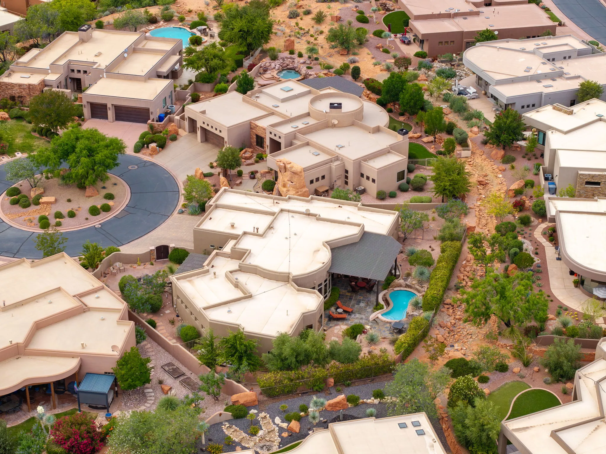 Modern desert architecture featuring a private swimming pool, covered patio, and extensive landscaping