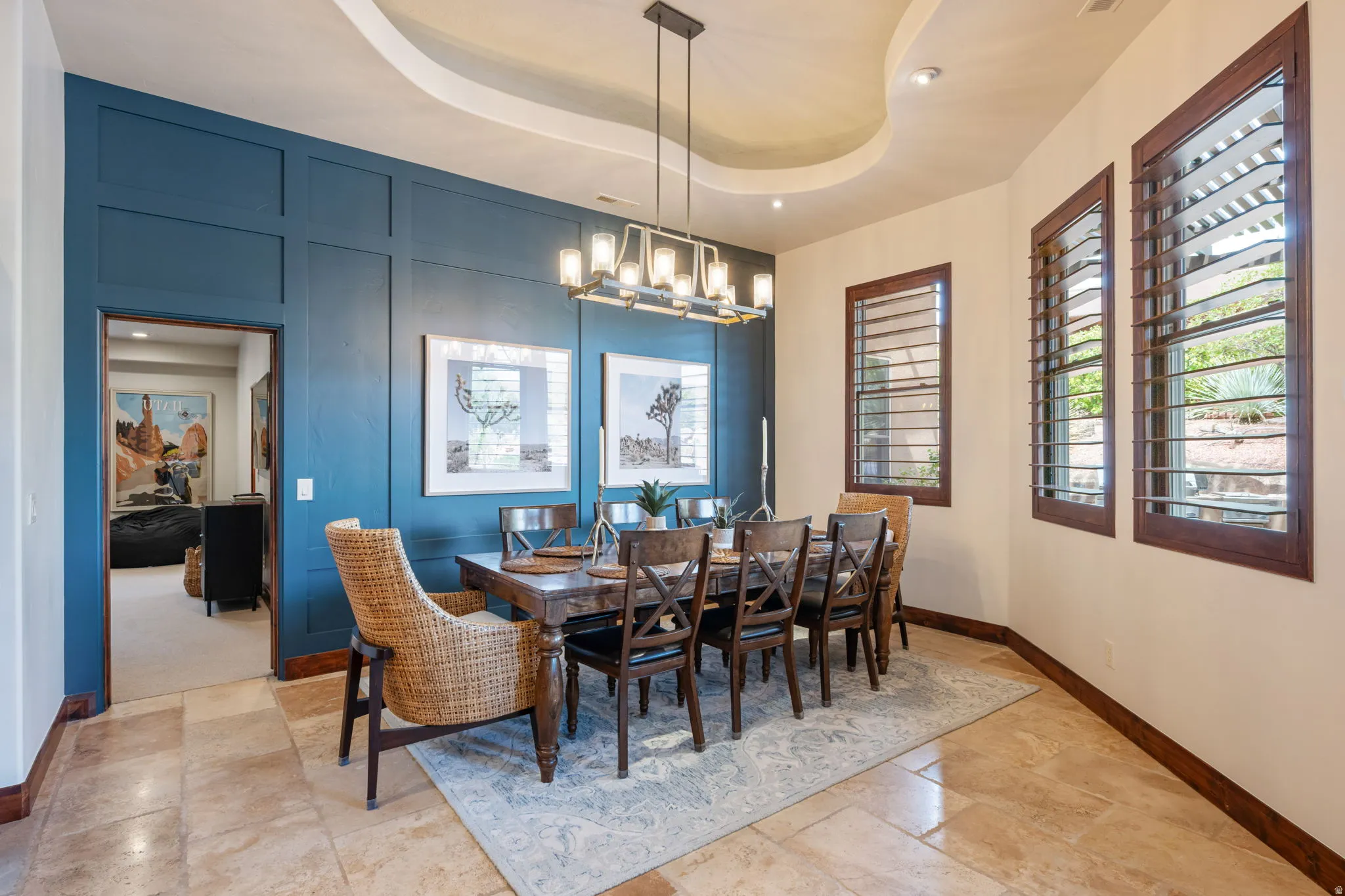 Formal dining space featuring a coffered ceiling with recessed lighting and a contemporary rectangular chandelier