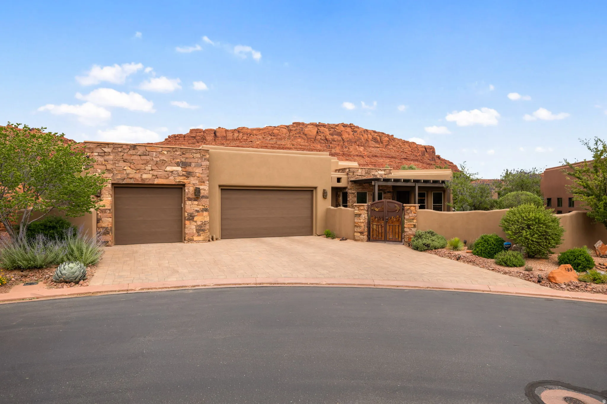 Adobe-style architecture featuring a stone facade and stucco exterior