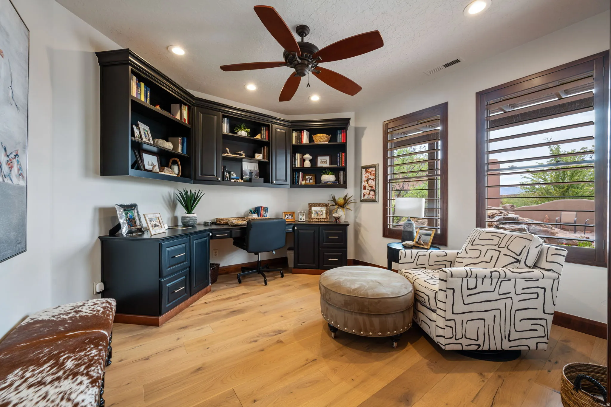 Custom built-in cabinetry and desk system featuring a dark finish