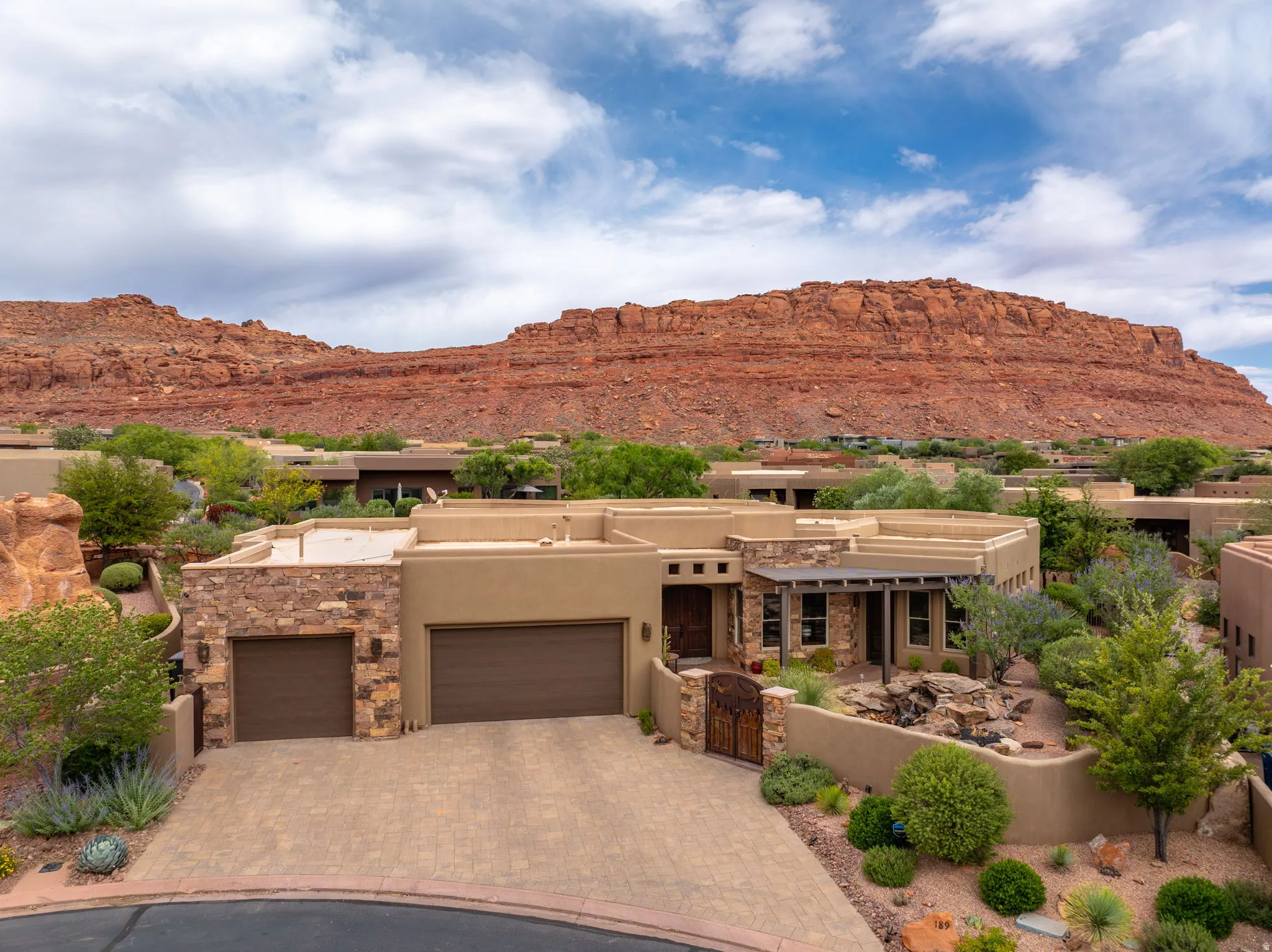 Southwestern-style residence featuring a prominent red rock mountain backdrop