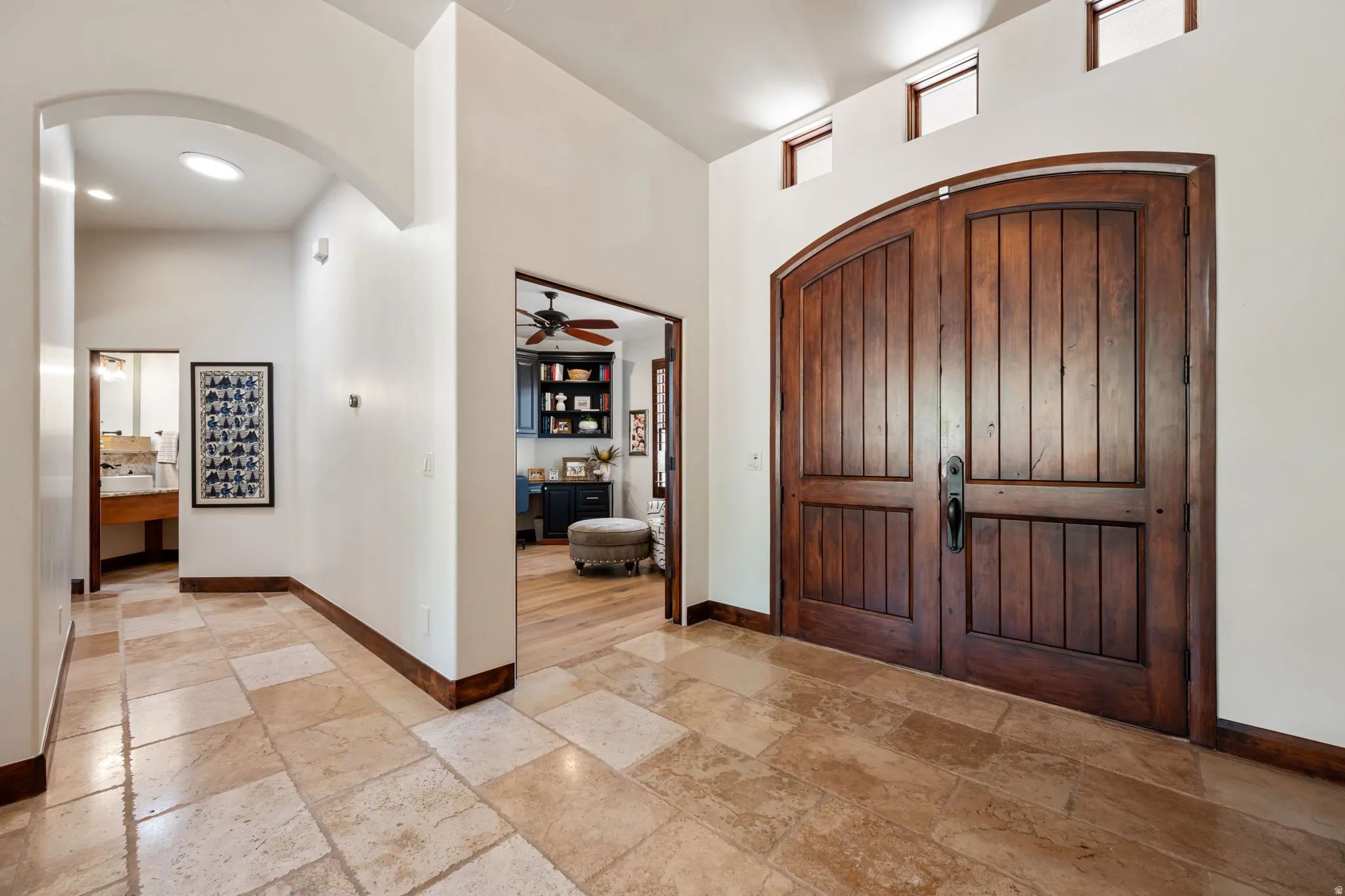 Arched wooden double entry doors with transom windows