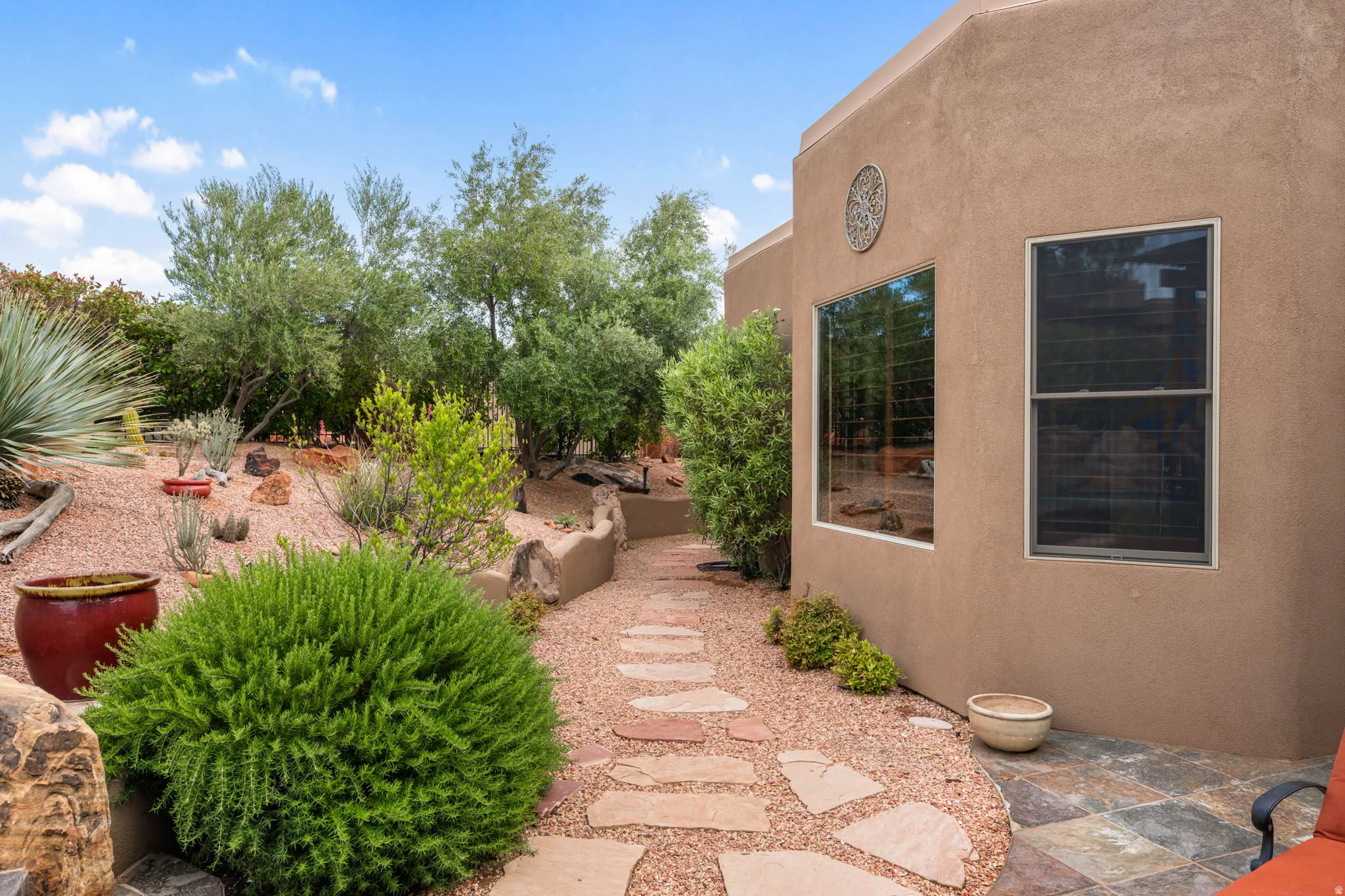 Southwest-style exterior featuring a stucco facade and multiple windows