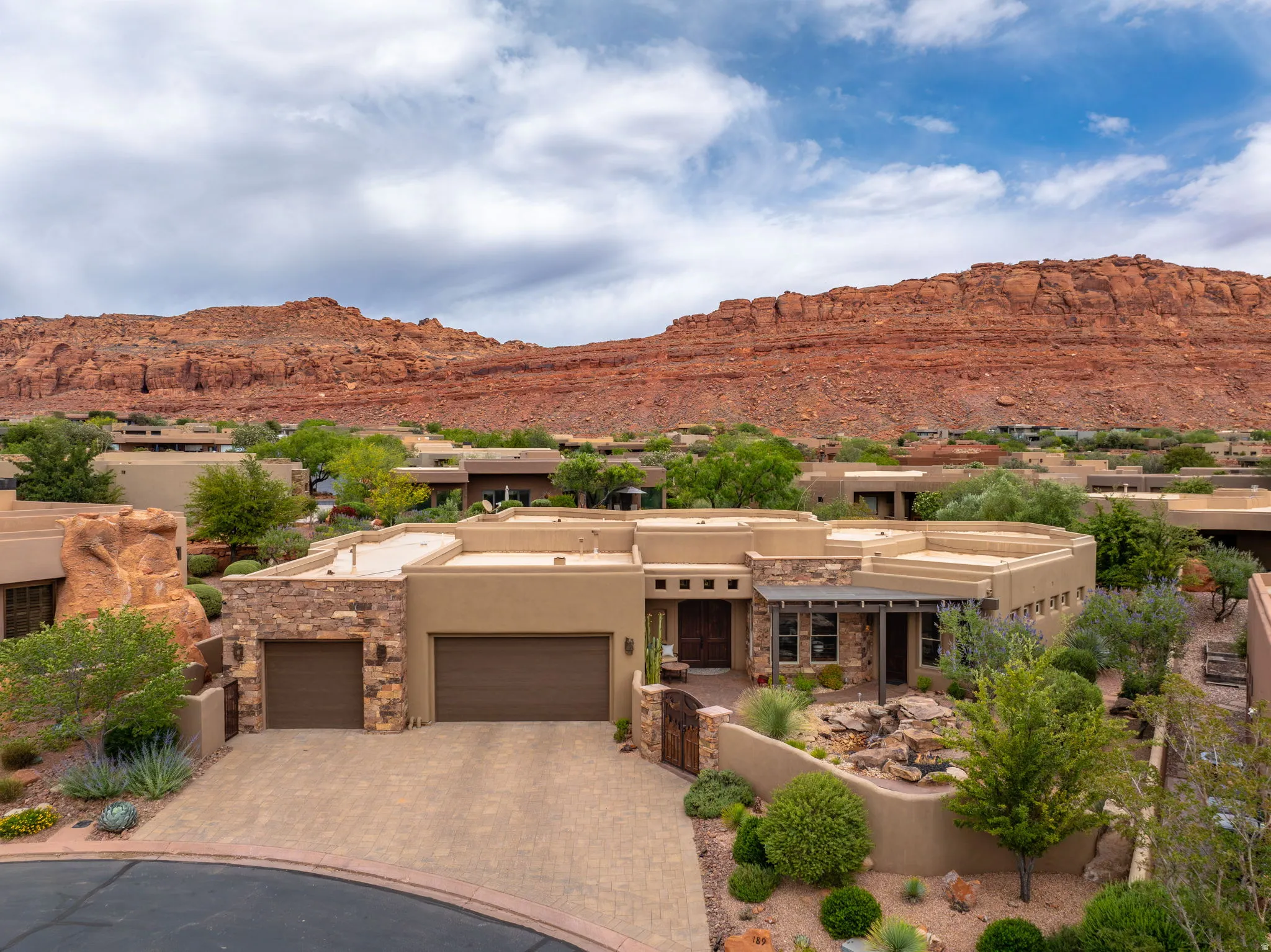 Southwestern-style residence featuring a stucco exterior and stone accents