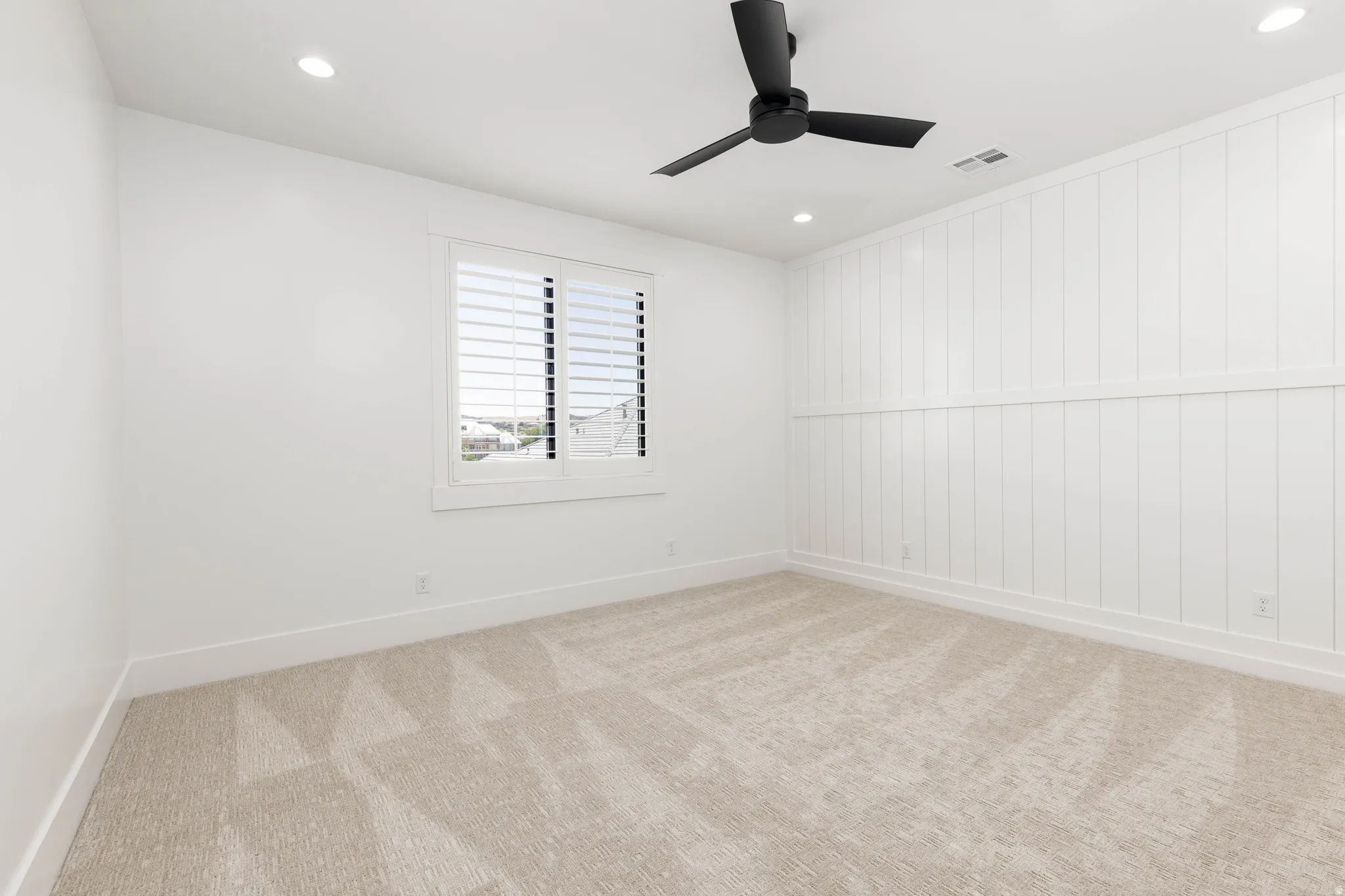 Neutral-toned carpet flooring complements the white walls and trim