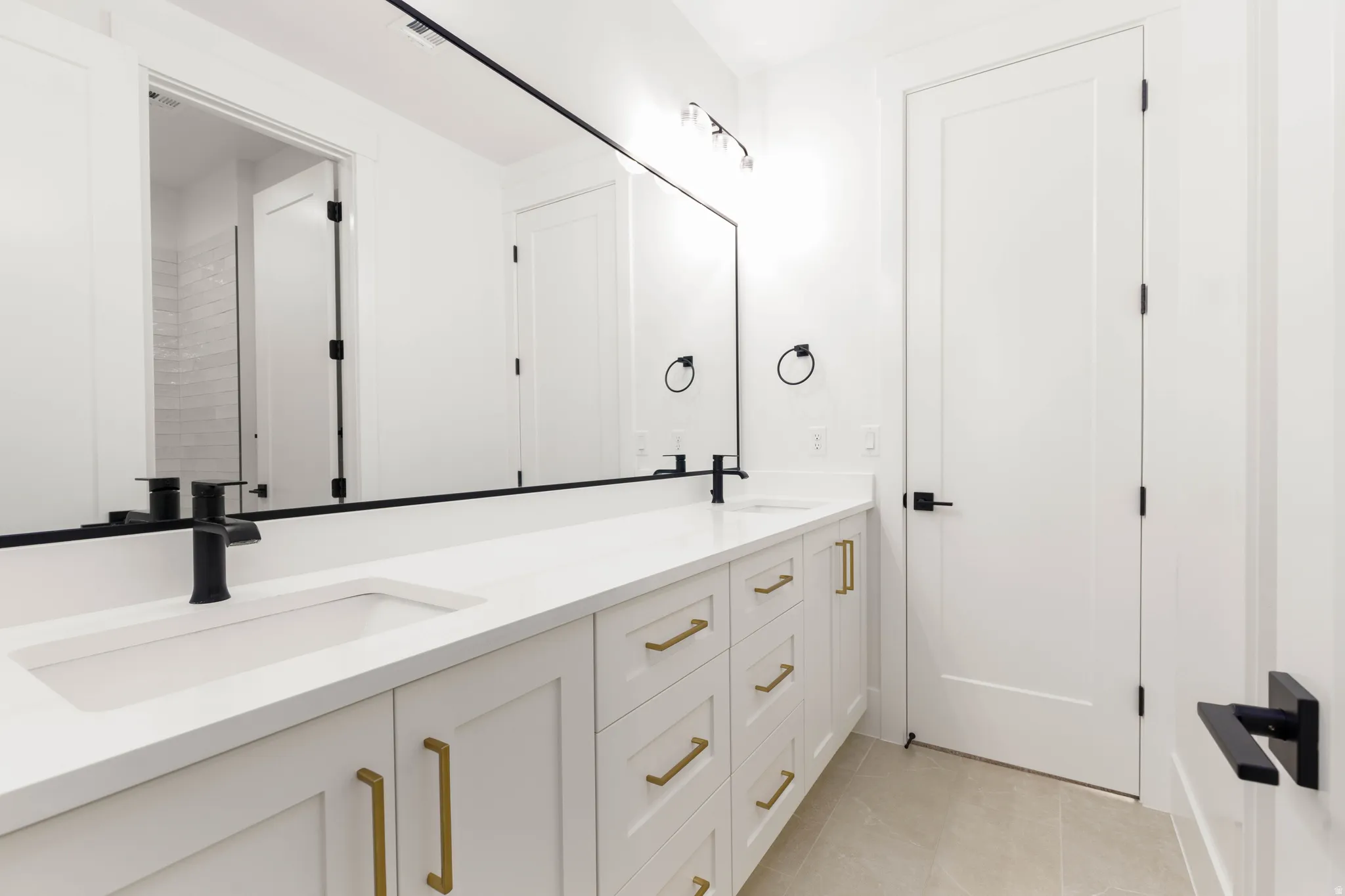 Double vanity with white cabinetry and integrated sinks