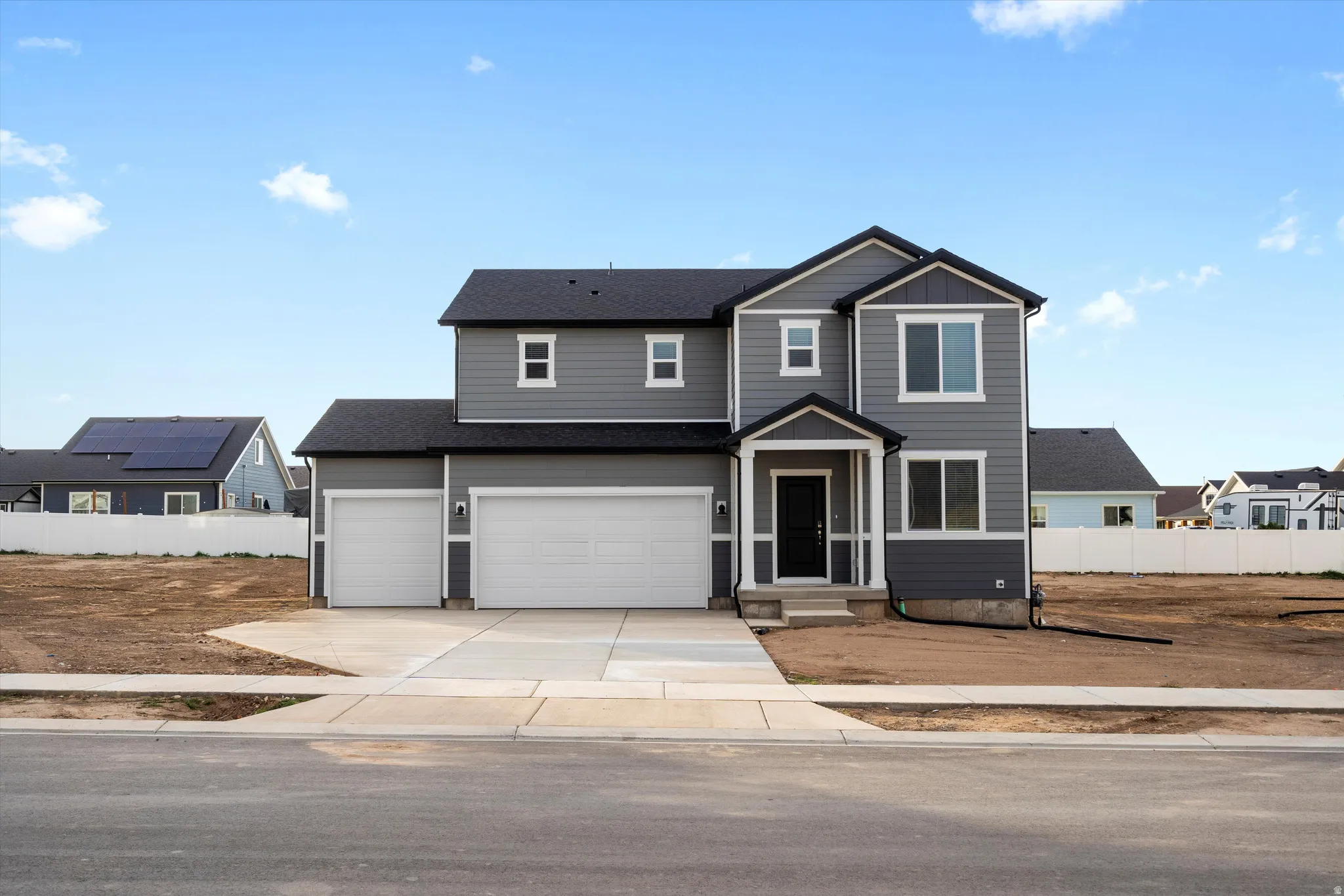 Modern two-story residence with gray siding and white trim