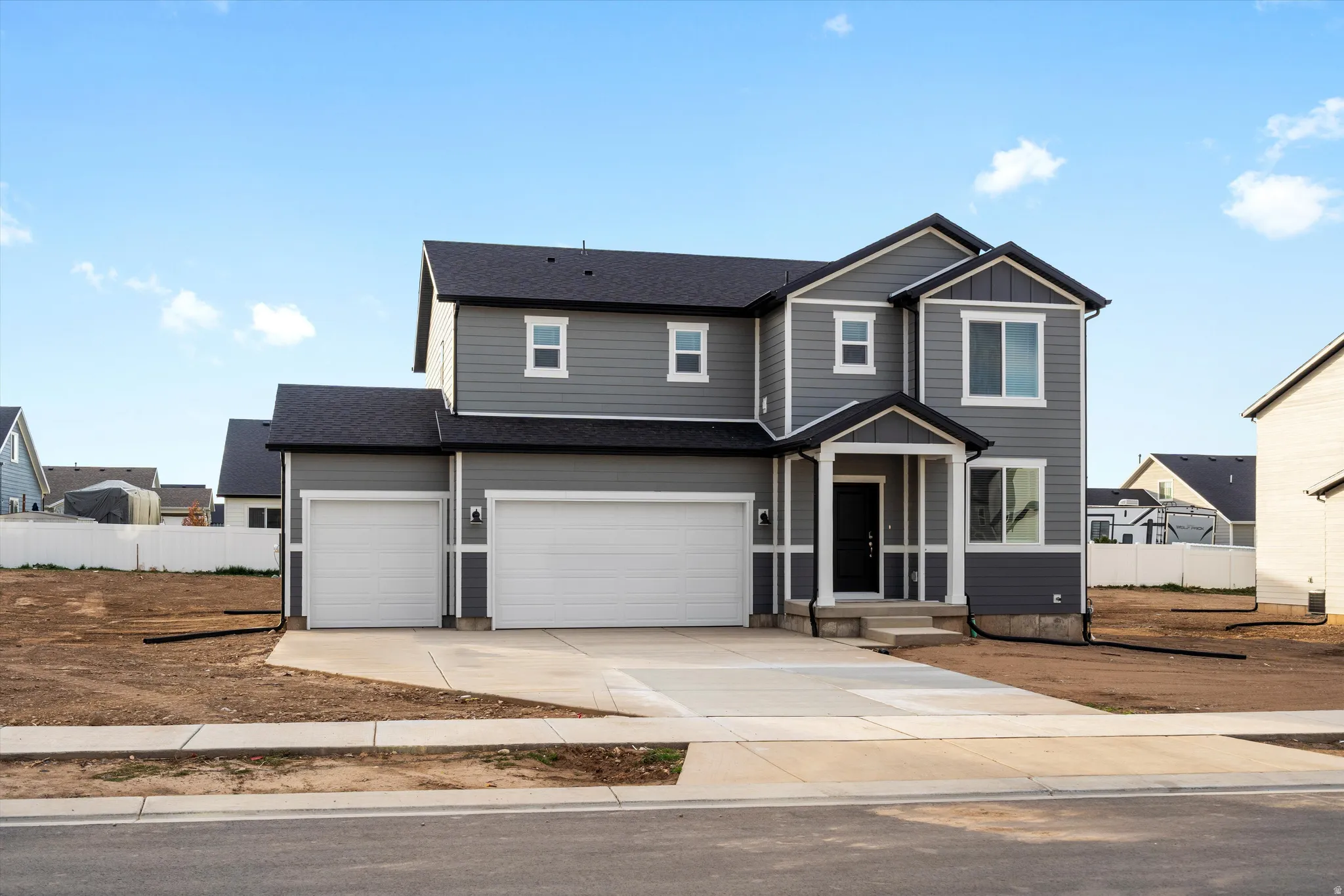 Contemporary two-story residence featuring gray siding with white trim accents