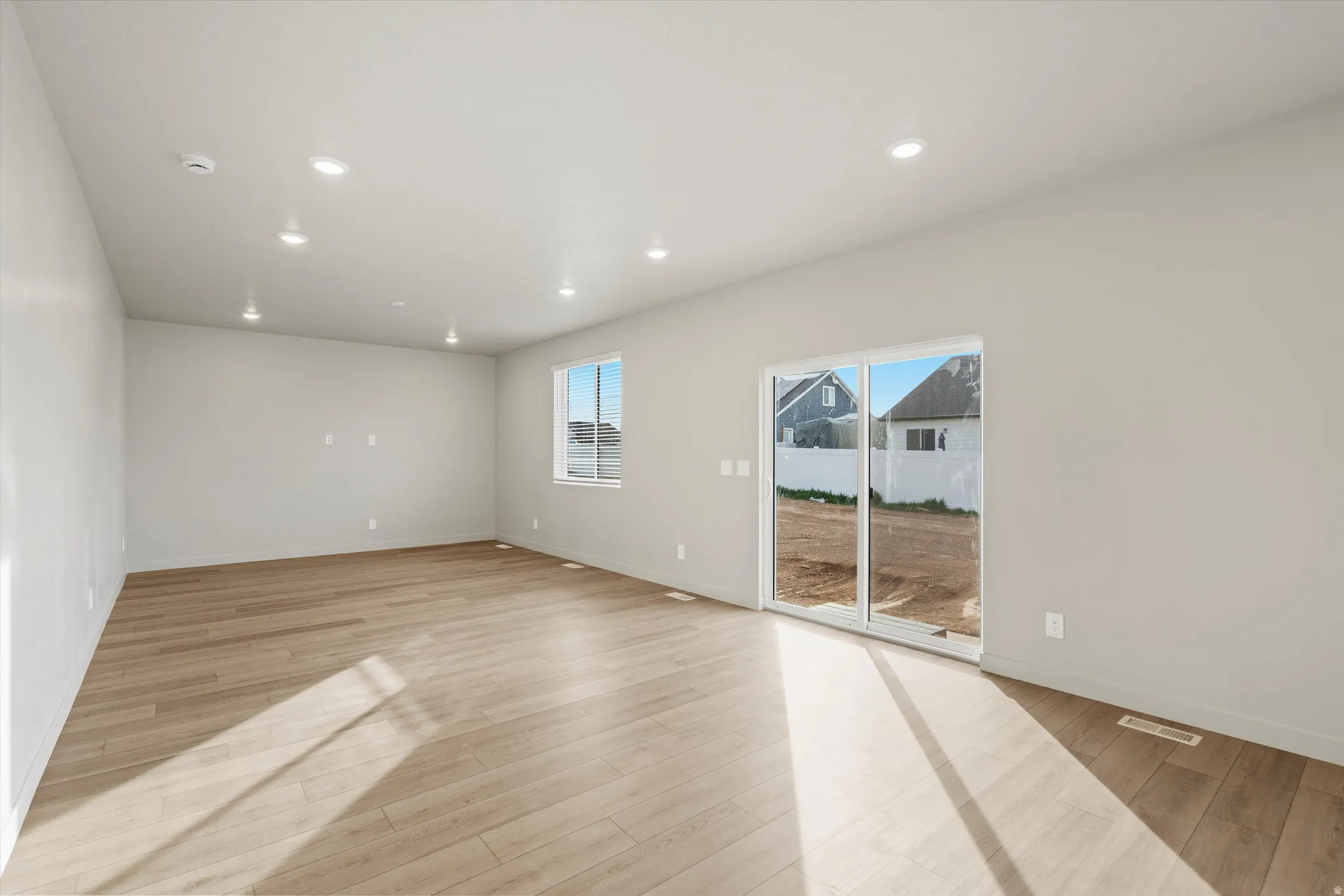 Spacious interior with neutral wall tones and wood-finish flooring