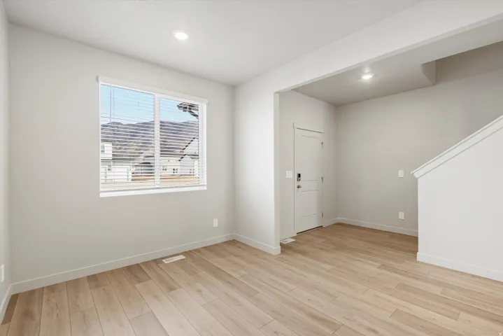 Spacious interior room with wood-finish flooring