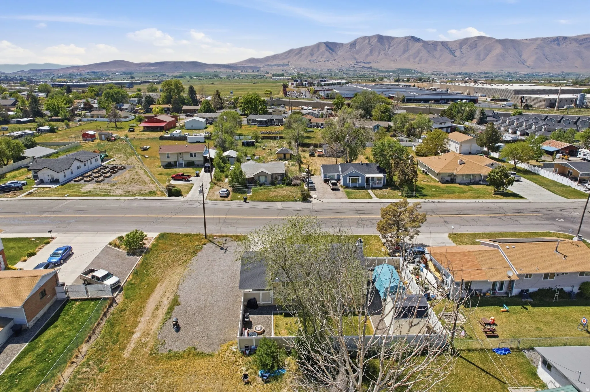 Aerial perspective showcasing a residential neighborhood with distant mountain ranges
