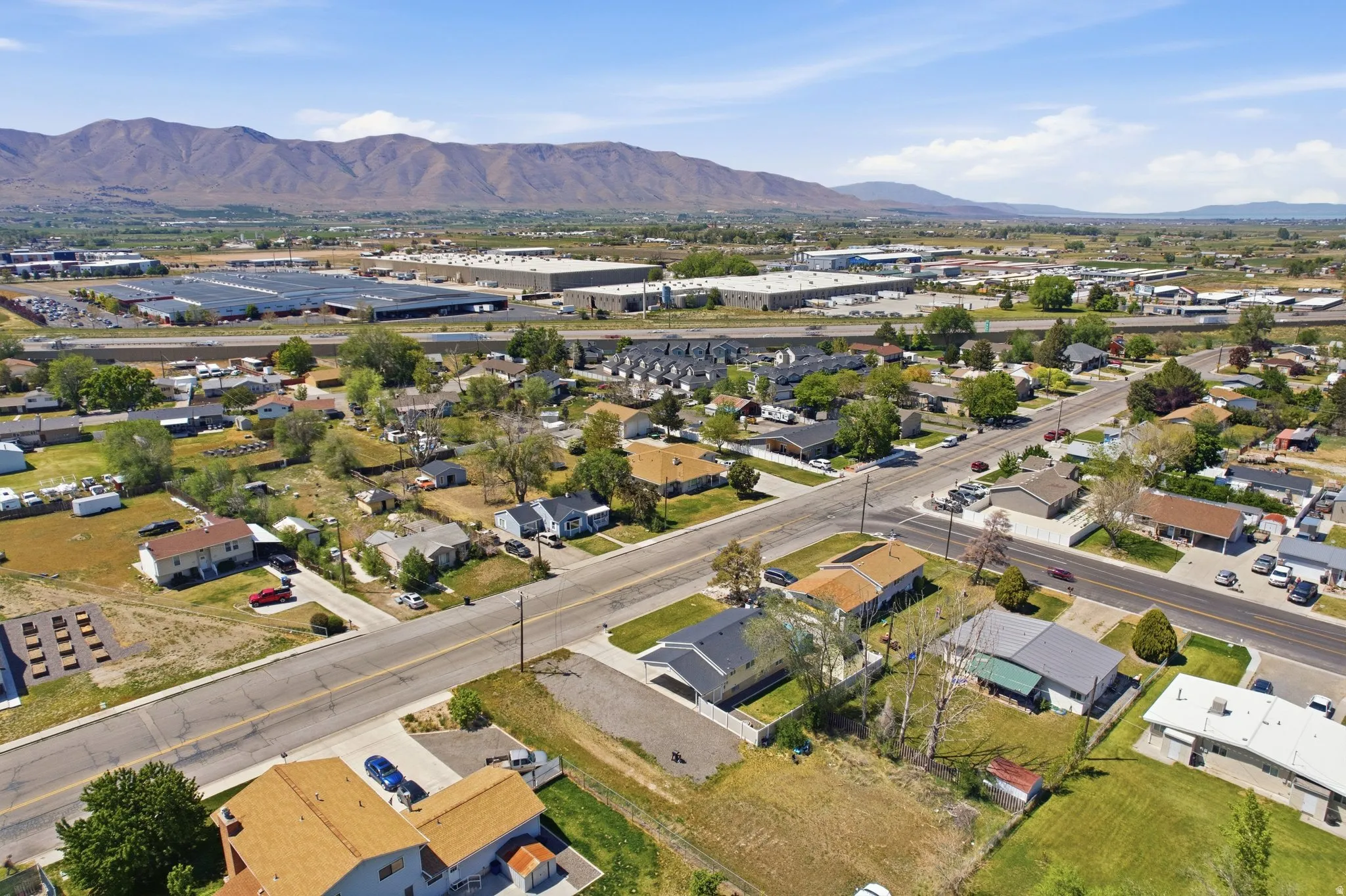 Aerial perspective showcasing a residential neighborhood with distant mountain ranges