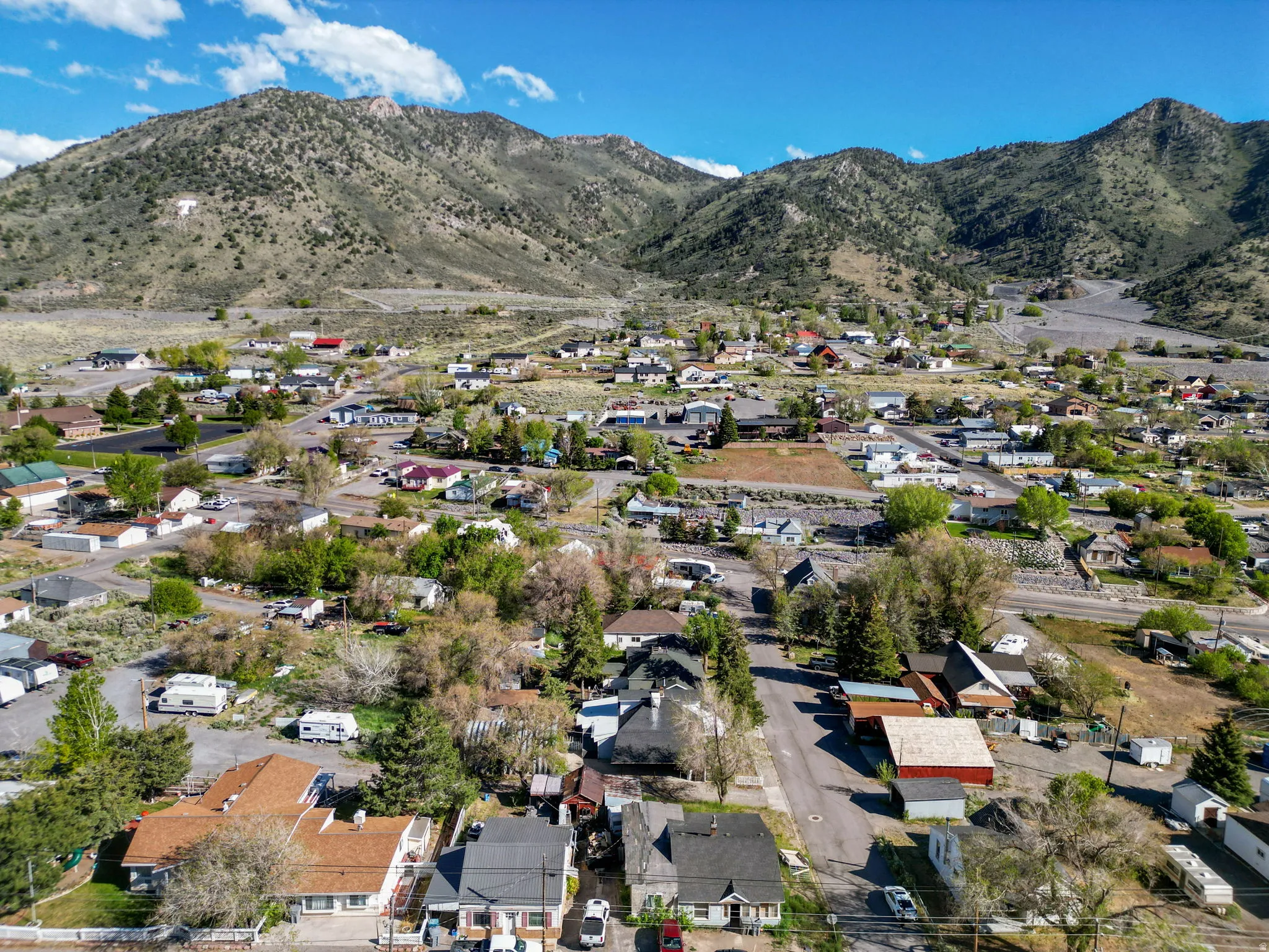 Aerial perspective showcasing a residential community nestled against a mountainous backdrop